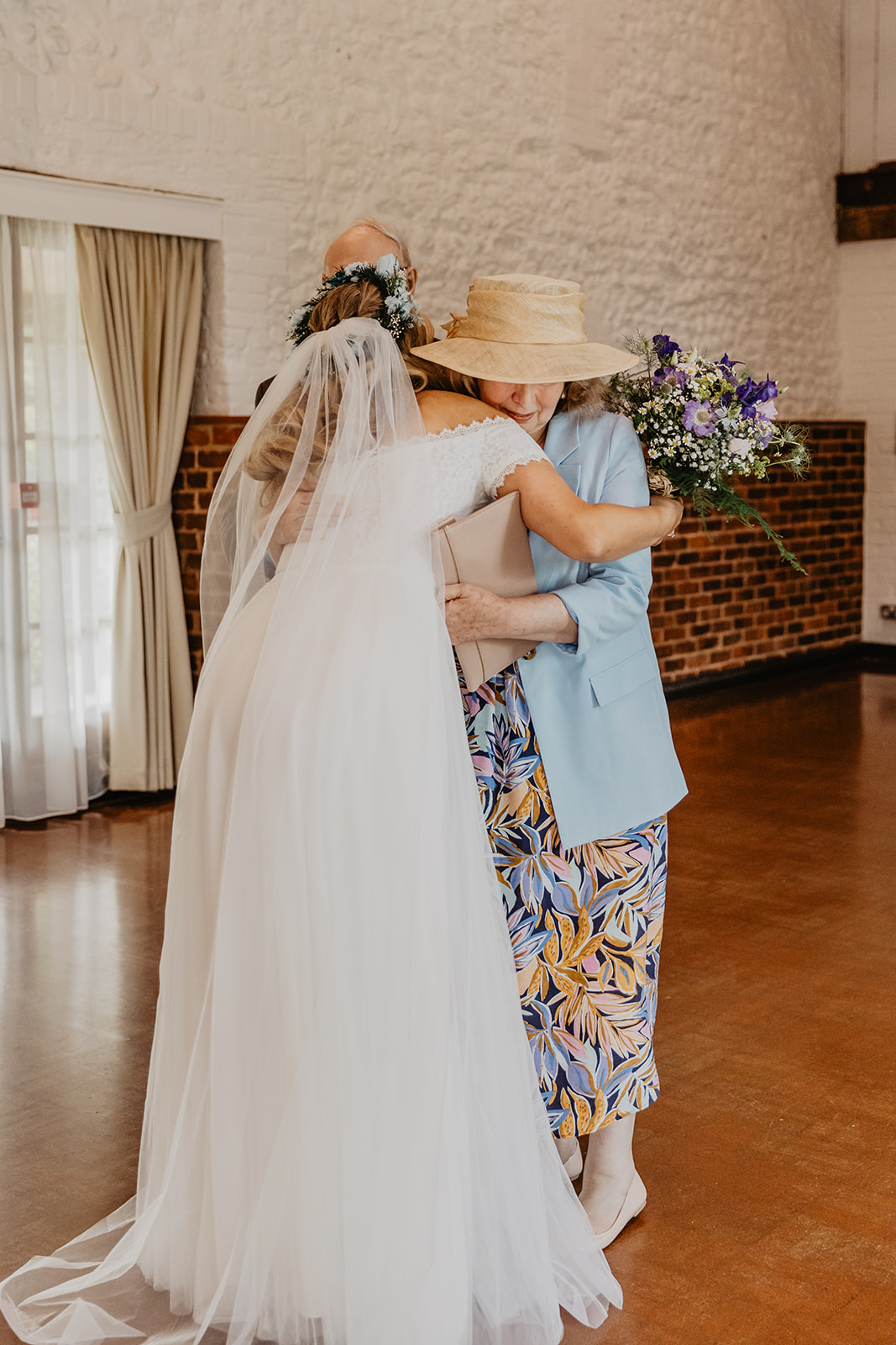 Bride and parents hugging at Field Place Wedding Worthing, Sussex. By OliveJoy Photography.