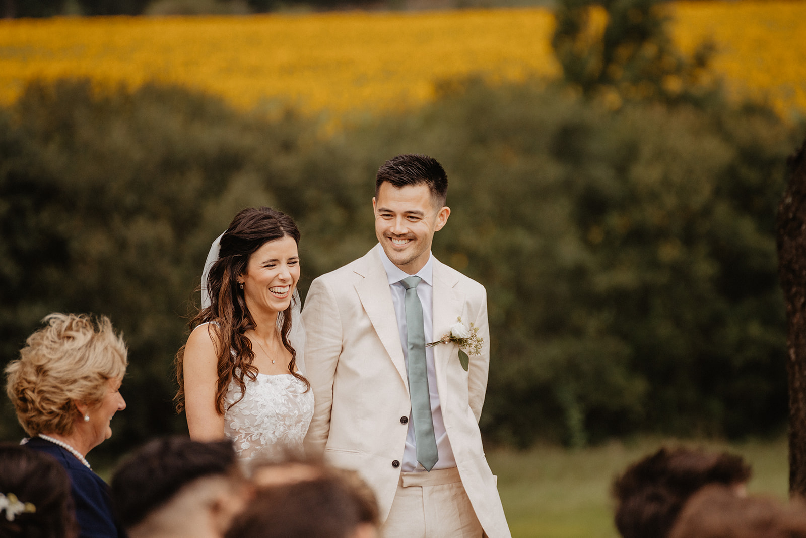 An english couple who gets married in france at their ceremony in front of a sunflower field 