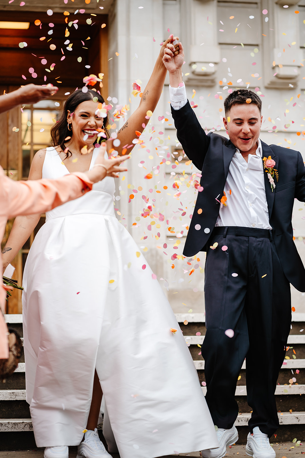 LGBTQ wedding confetti moment at Hackney Town Hall with colourful, bold florals