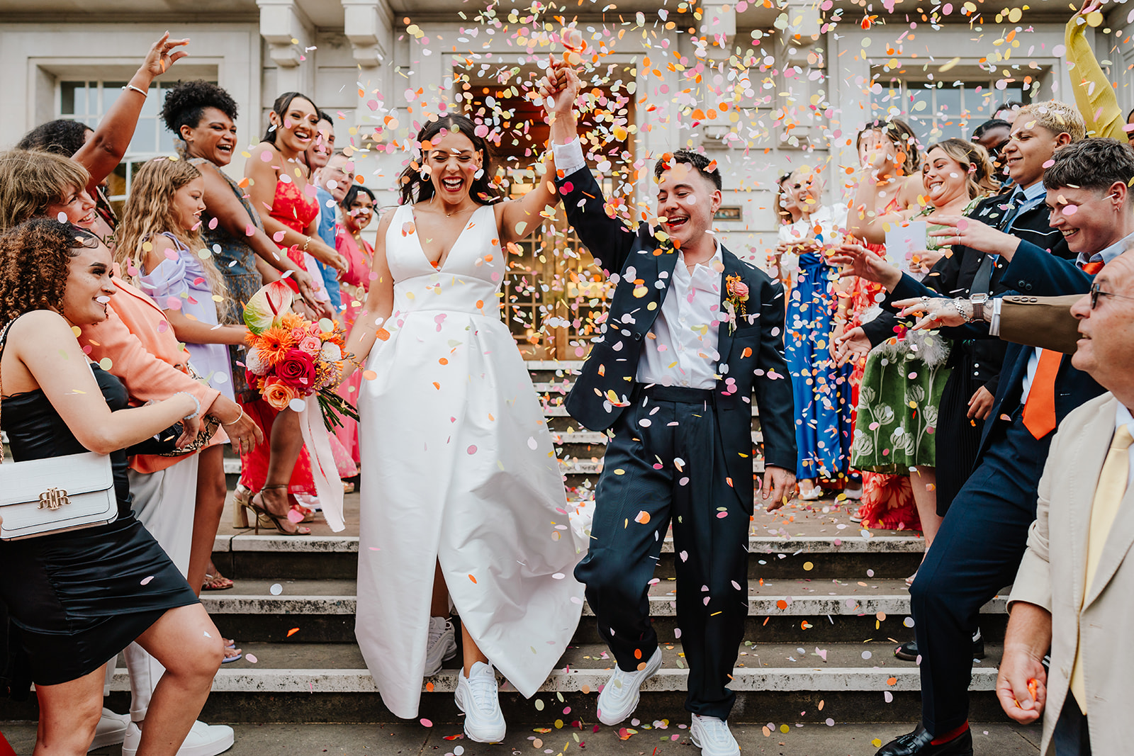LGBTQ wedding confetti moment at Hackney Town Hall with colourful, bold florals