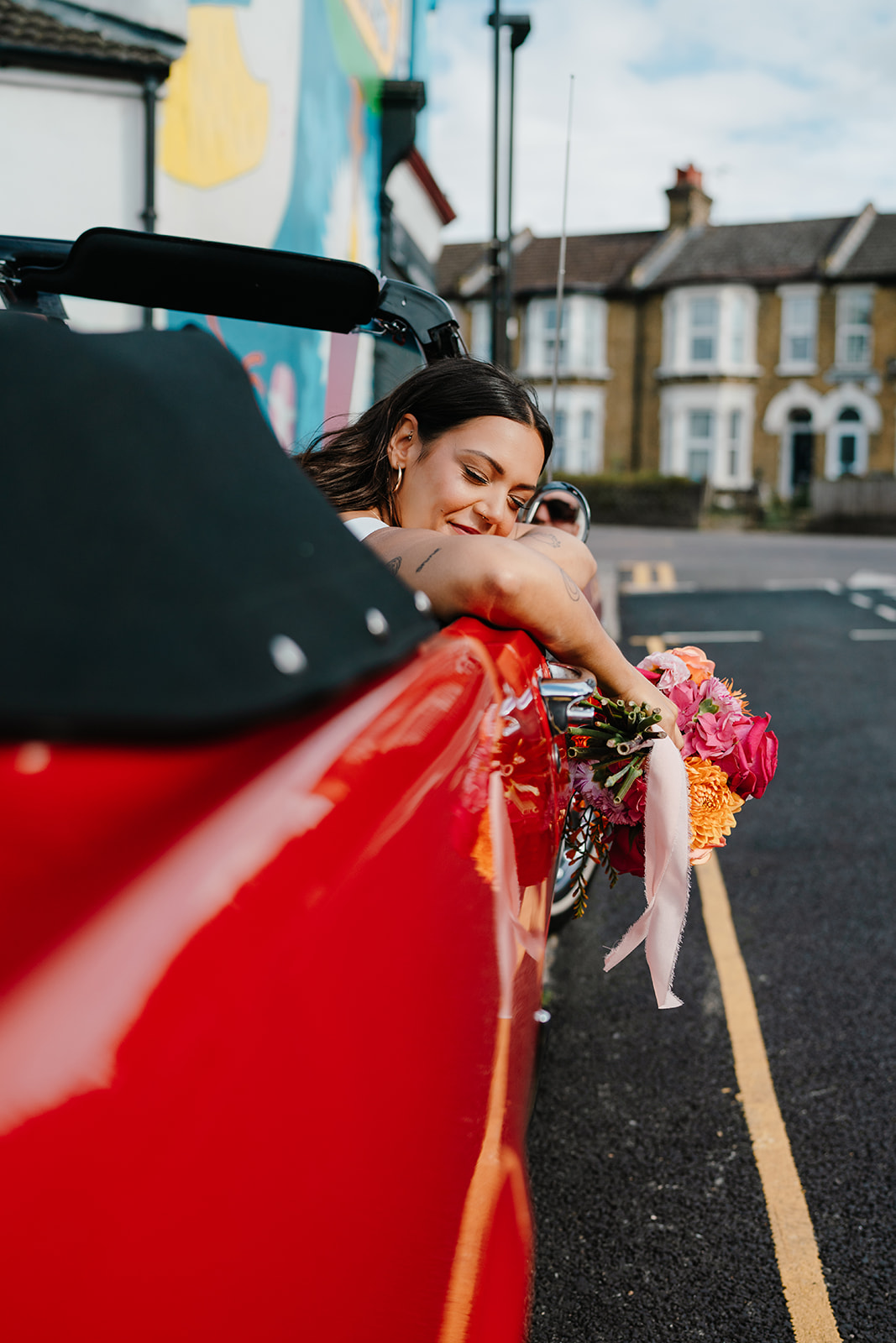 LGBTQ wedding couple in Hackney during relaxed couple portraits in vintage mustang car