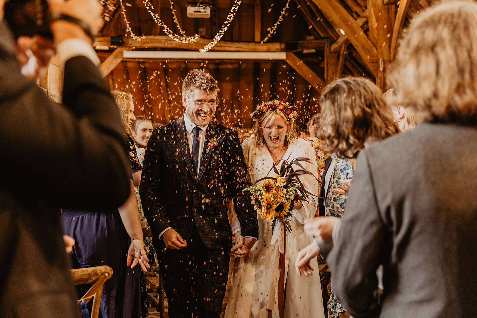 Bride and groom with confetti at a wedding at Gilbert White's Hampshire. By OliveJoy Photography.