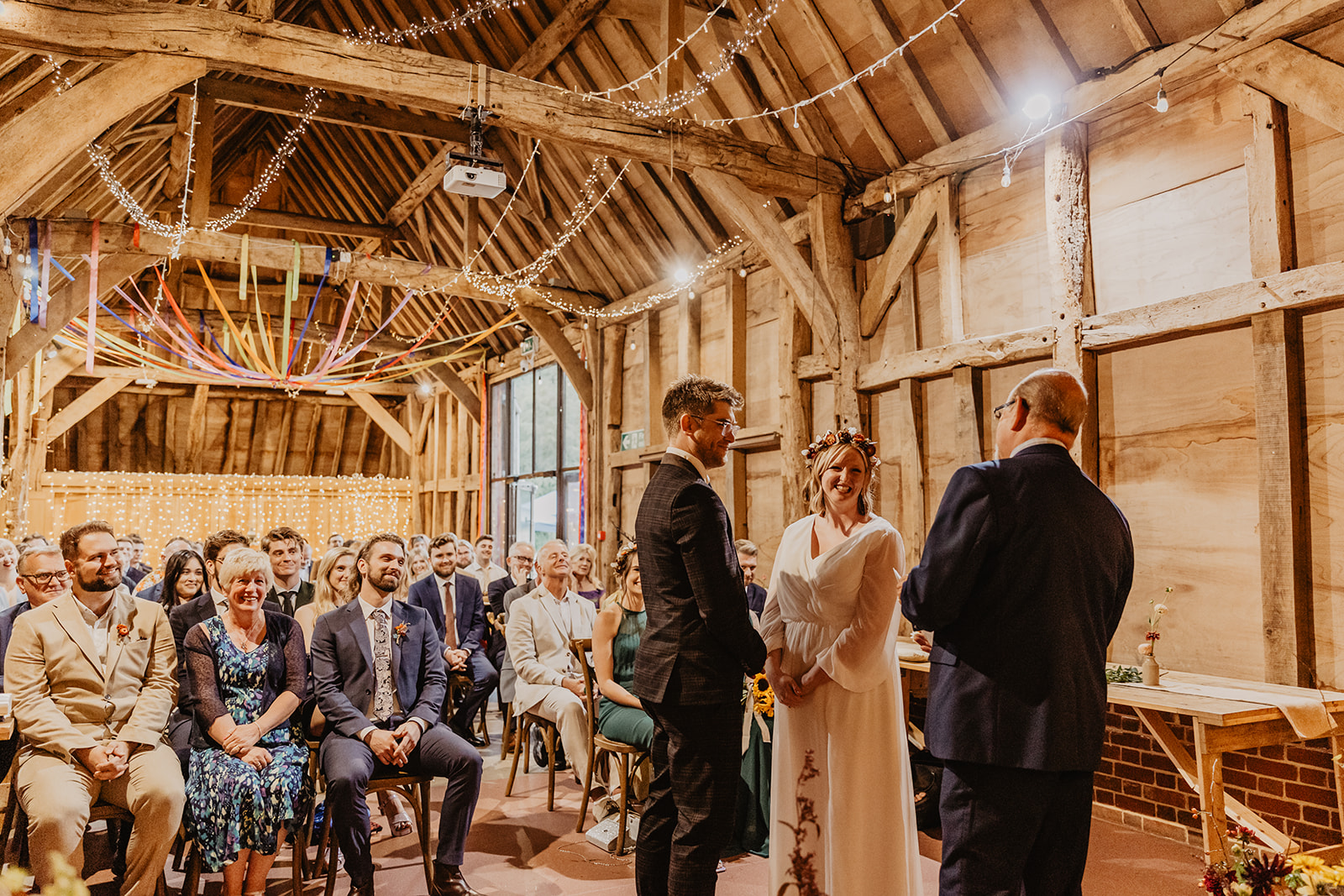 Bride and groom saying vows at a wedding at Gilbert White's Hampshire. By OliveJoy Photography.