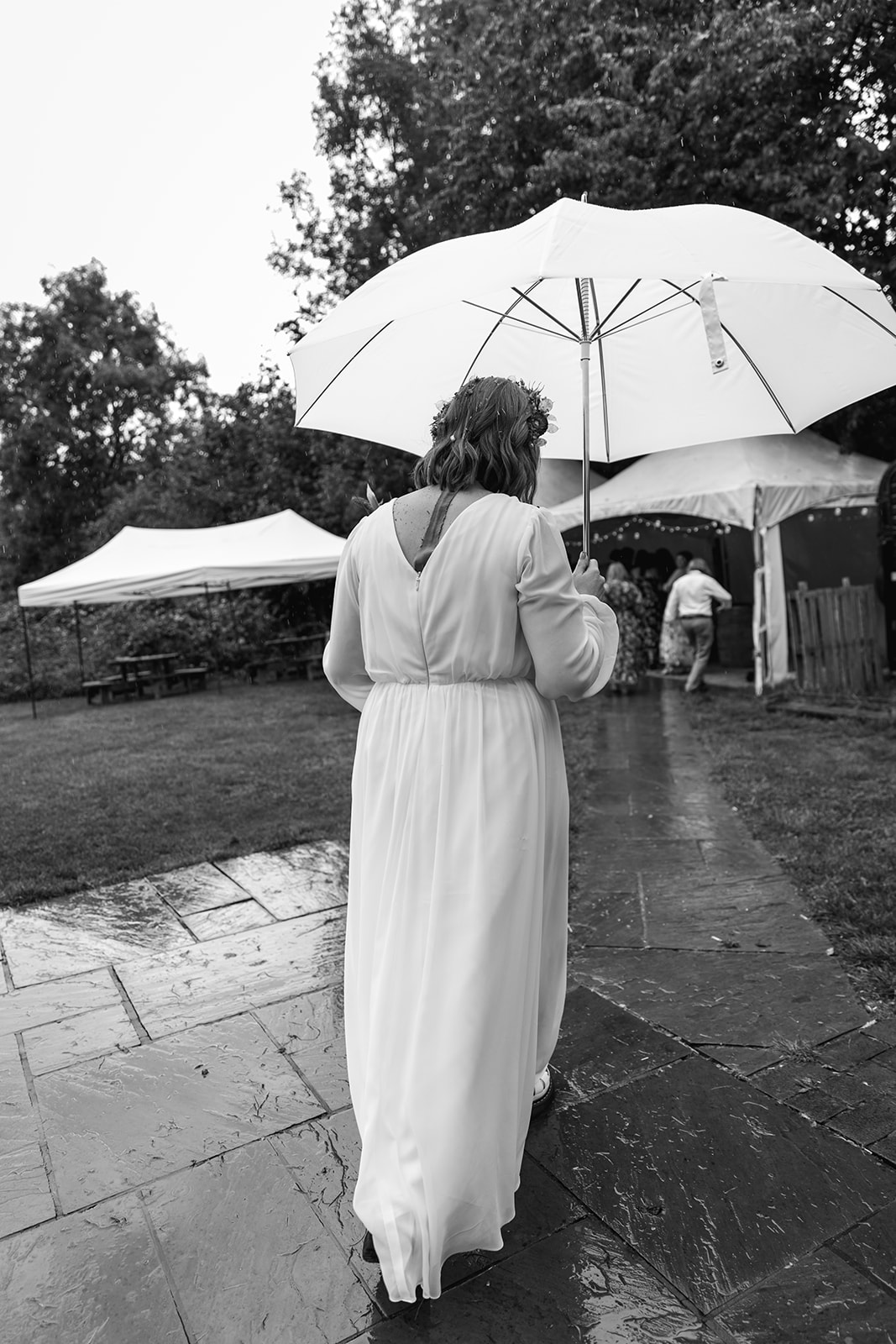 Bride with umbrella at a wedding at Gilbert White's Hampshire. By OliveJoy Photography.
