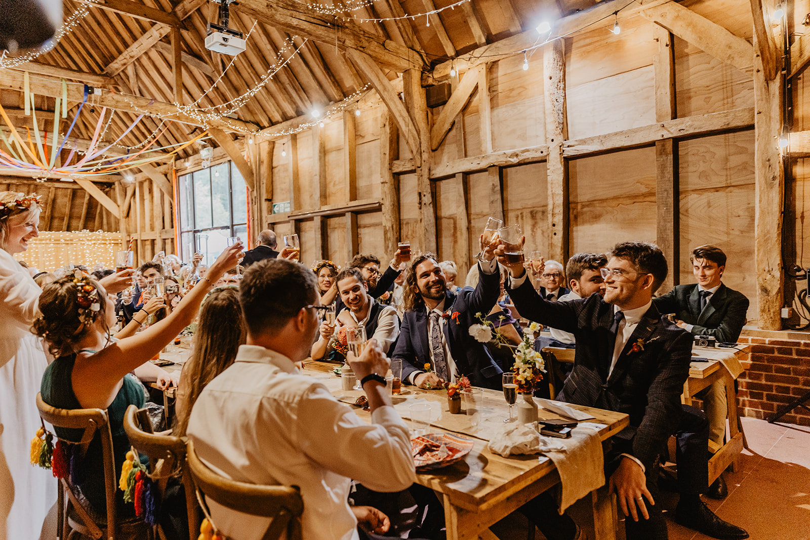 Guests toasting at a reception at a wedding at Gilbert White's Hampshire. By OliveJoy Photography.
