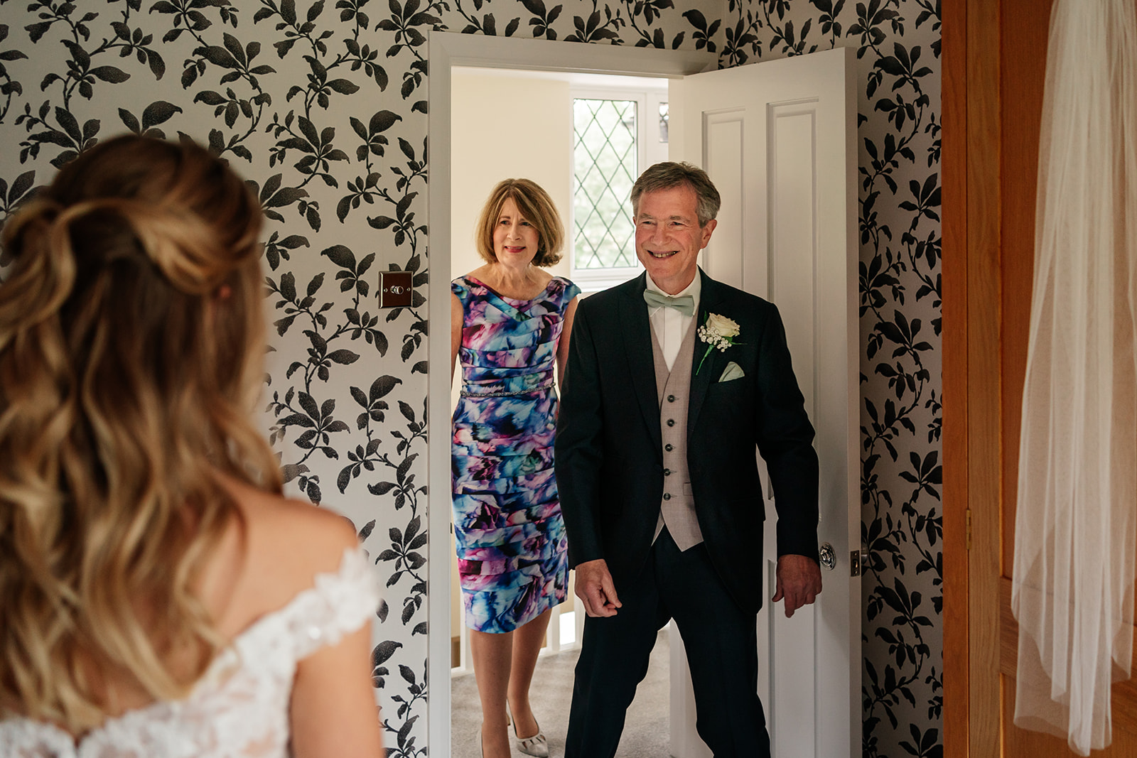 Mum and dad seeing their daughter in her wedding dress for the first time 