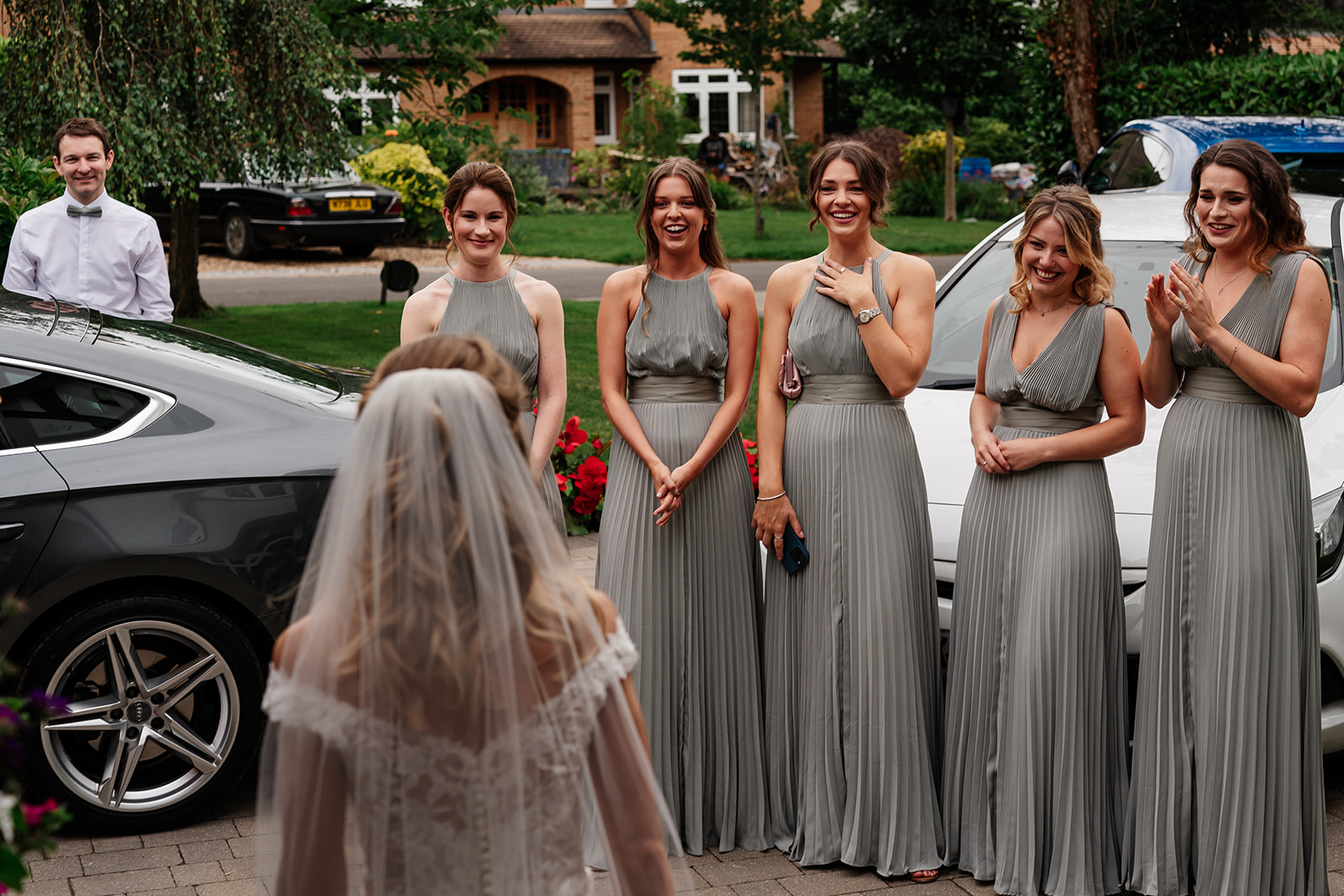 Bridesmaids seeing bride in her dress for the first time 