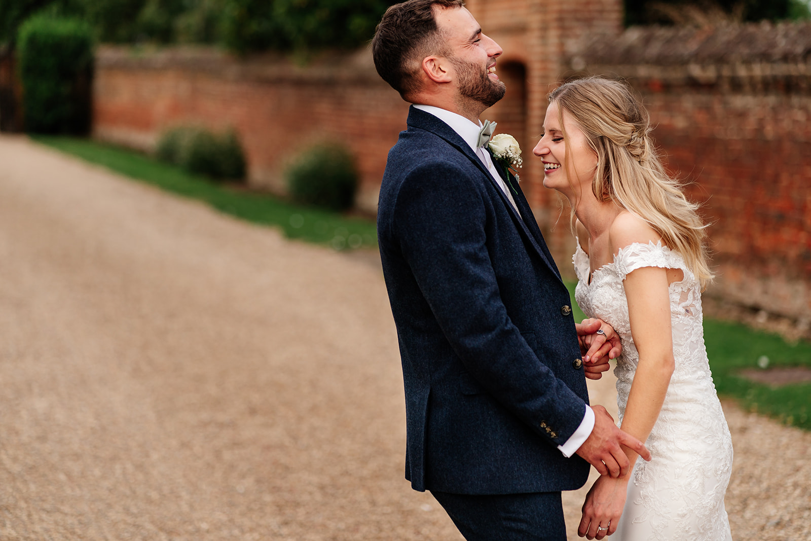 Bride and groom laughing in portrait photo of them at Lilllibrooke Manor