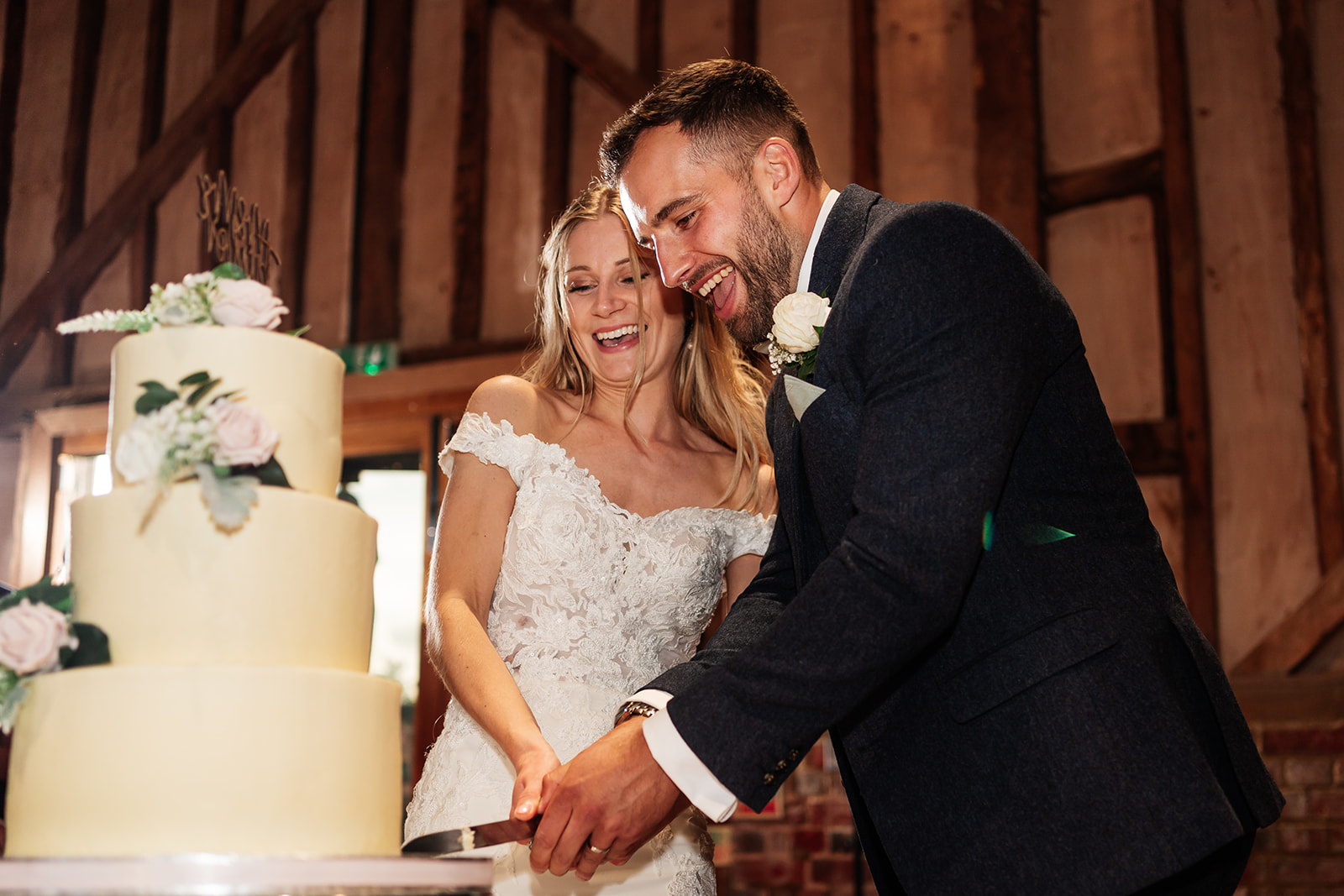 Bride and groom cutting the wedding cake at Lilllibrooke Manor