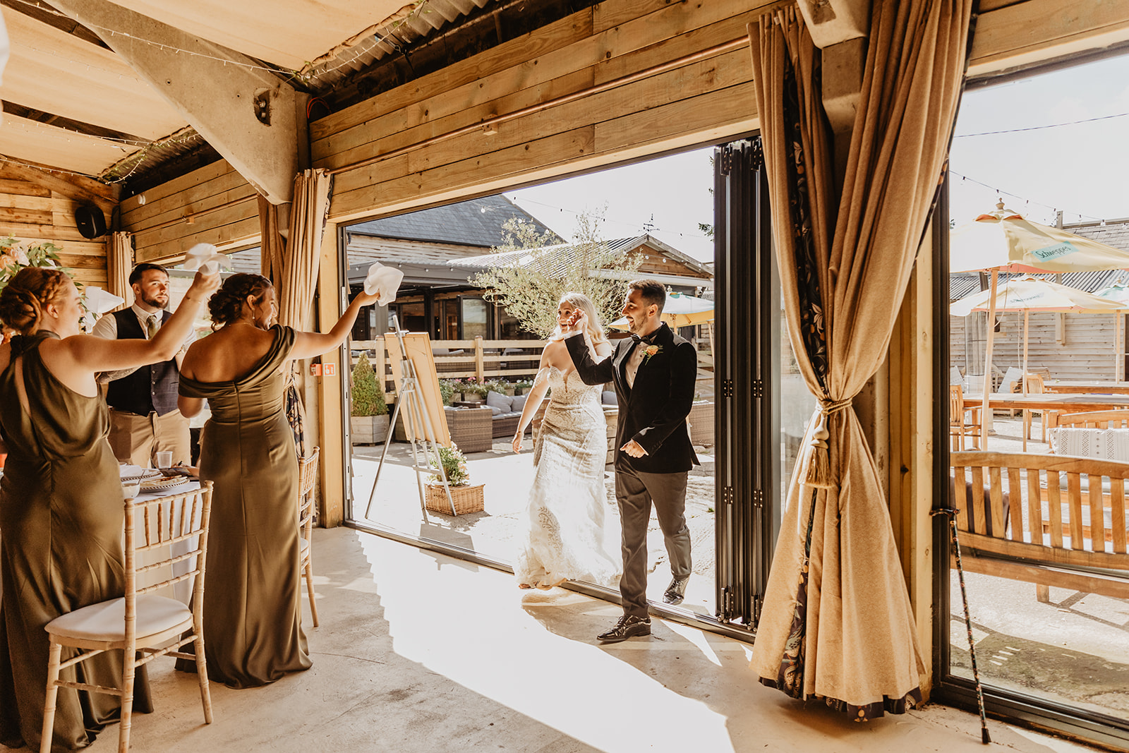 Bride and groom arriving at reception at a Southlands barn wedding, Sussex. Photo by OliveJoy Photography.