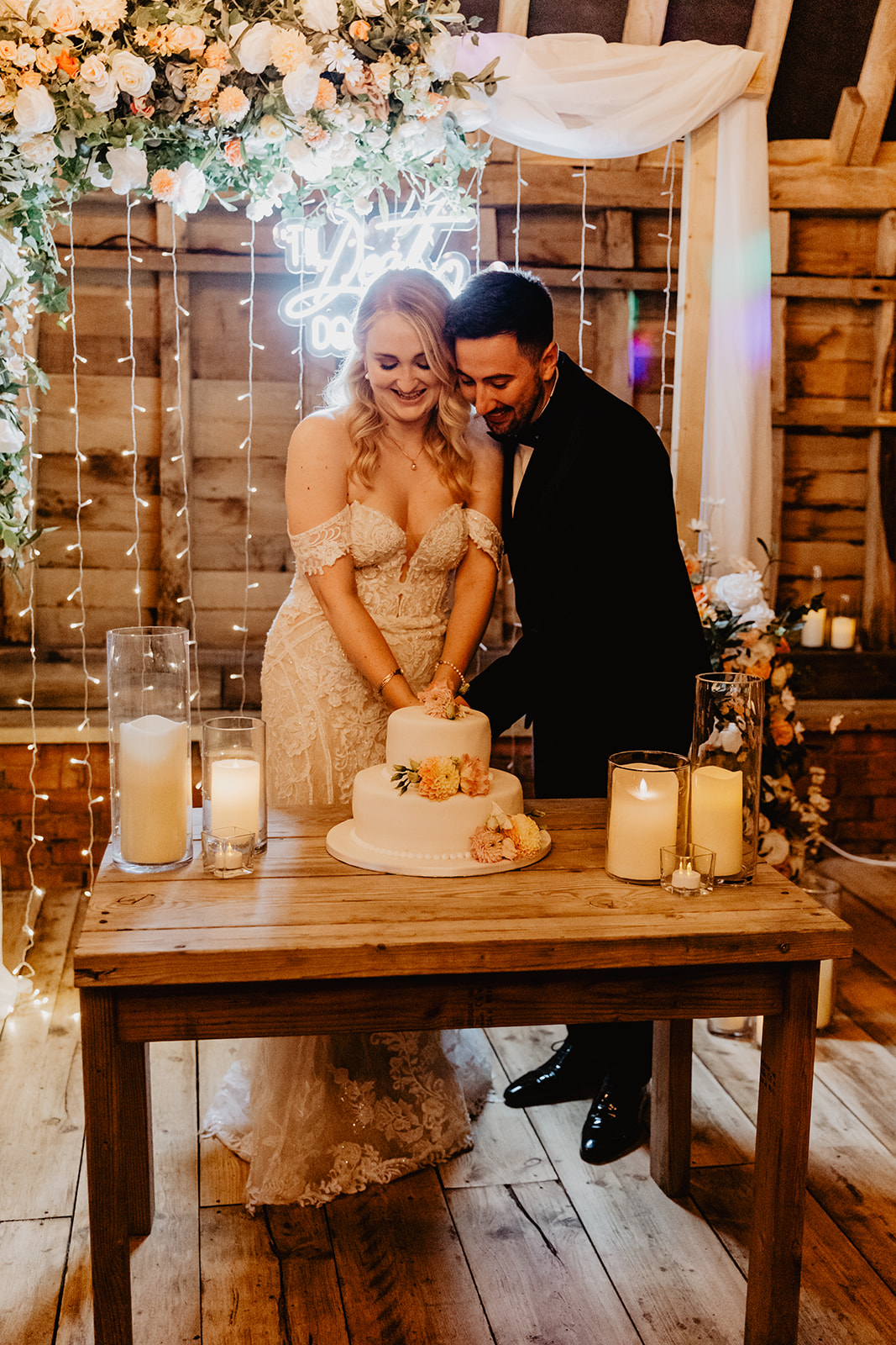 Bride and groom cut the cake at a Southlands barn wedding, Sussex. Photo by OliveJoy Photography.
