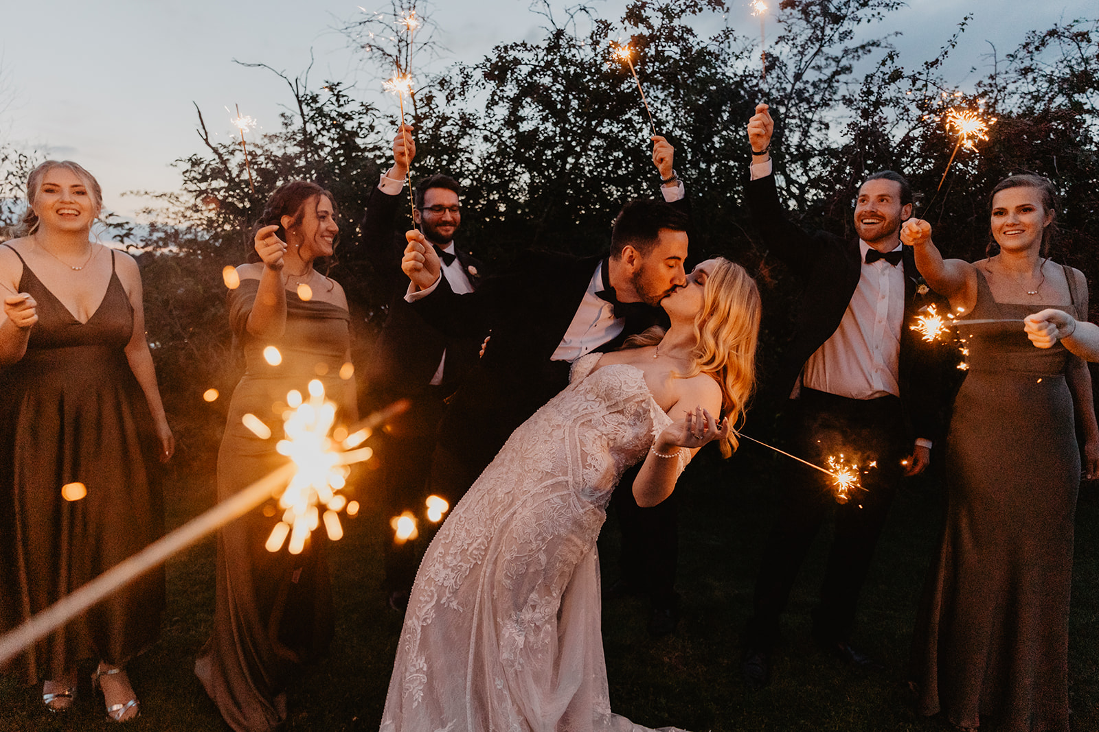 Bride and groom surrounded by sparklers at a Southlands barn wedding, Sussex. Photo by OliveJoy Photography.