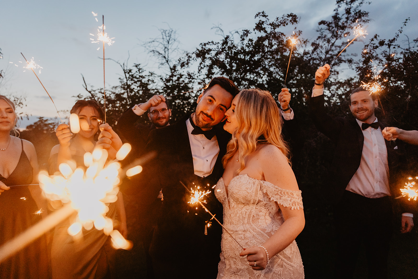 Bride and groom surrounded by sparklers at a Southlands barn wedding, Sussex. Photo by OliveJoy Photography.