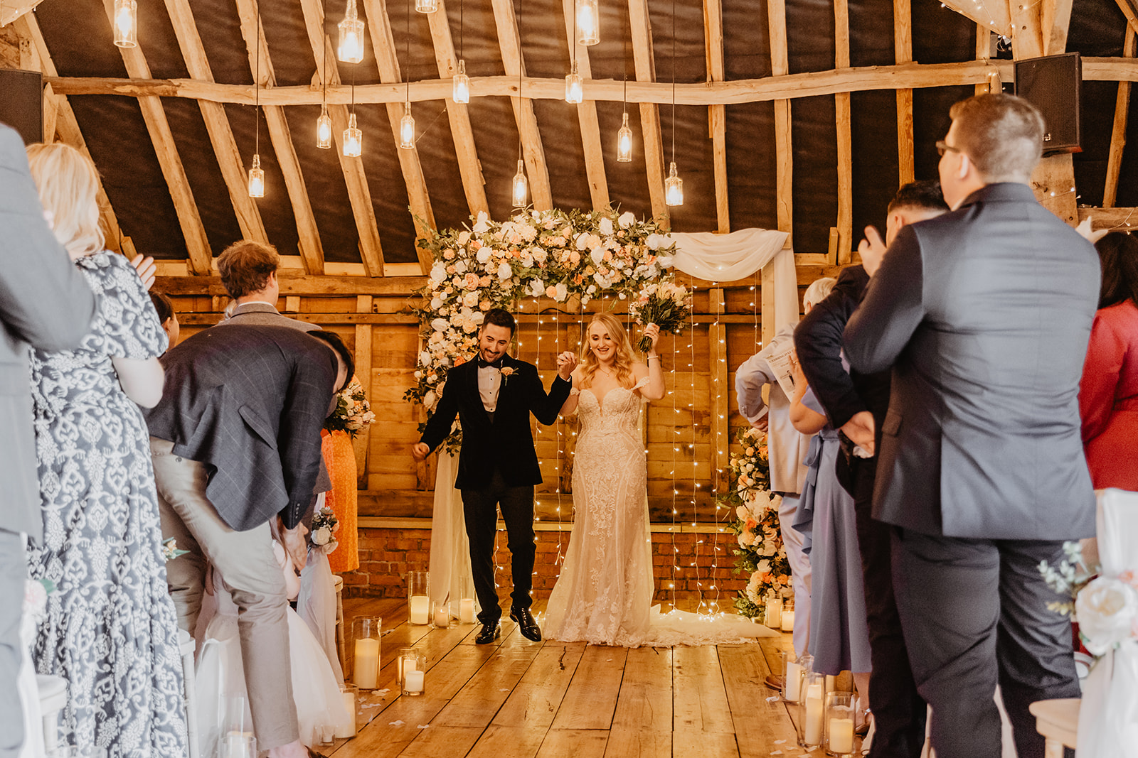Bride and groom walk down the aisle at a Southlands barn wedding, Sussex. Photo by OliveJoy Photography.