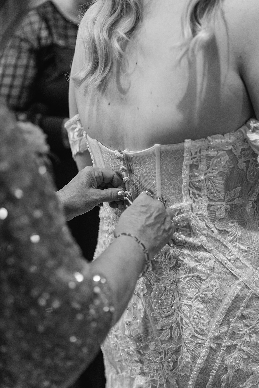 Bride putting on her dress at a Southlands barn wedding, Sussex. Photo by OliveJoy Photography.