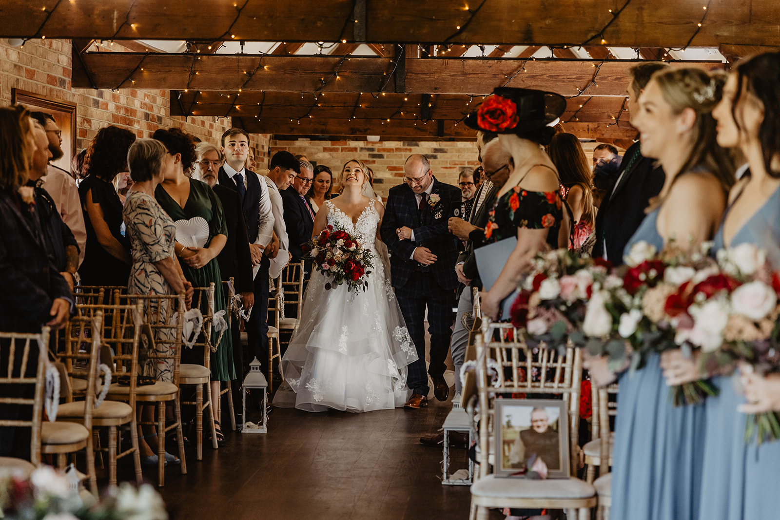 Bride and father of the bride walking down the aisle at a wedding at Long Furlong Barn, Sussex. By OliveJoy Photography.