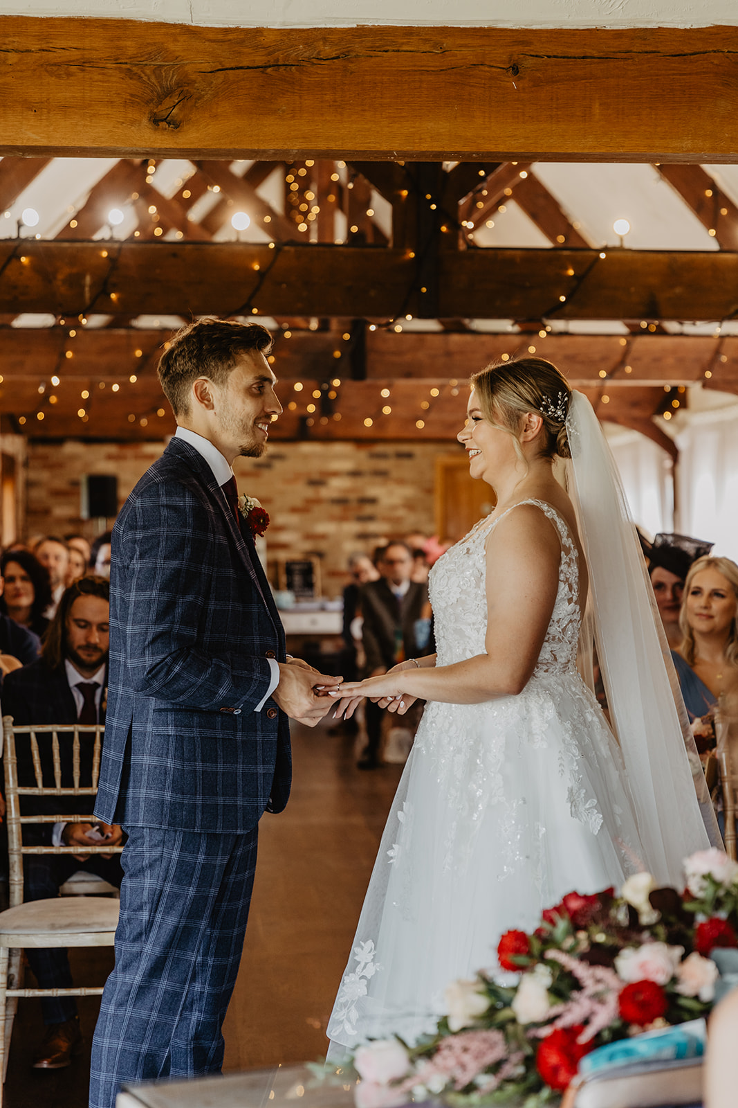 Bride and groom exchange vows at a wedding at Long Furlong Barn, Sussex. By OliveJoy Photography.