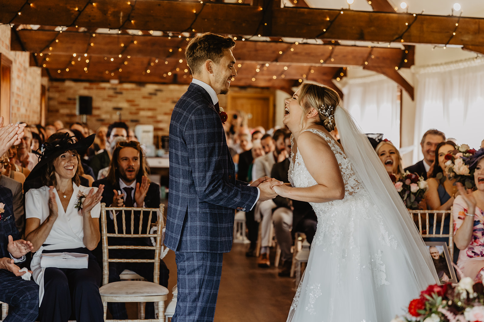 Bride and groom exchange vows at a wedding at Long Furlong Barn, Sussex. By OliveJoy Photography.