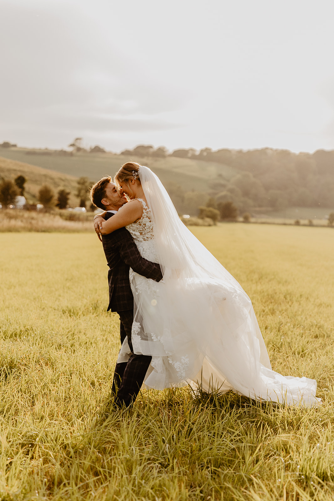 Bride and groom at sunset at a wedding at Long Furlong Barn, Sussex. By OliveJoy Photography