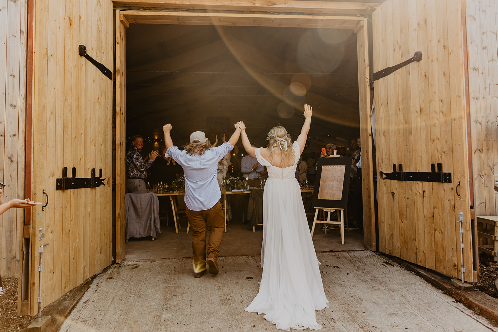 Bride and Groom arrive at the reception at a wedding at Mac's Farm in Sussex. By OliveJoy Photography.