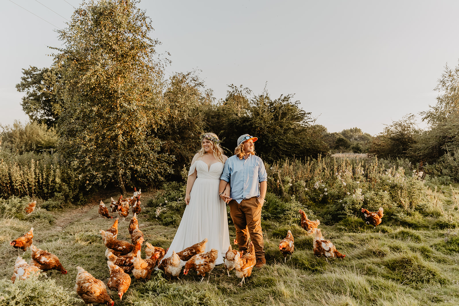 Bride and groom with their chickens at a wedding at Mac's Farm in Sussex. By OliveJoy Photography.