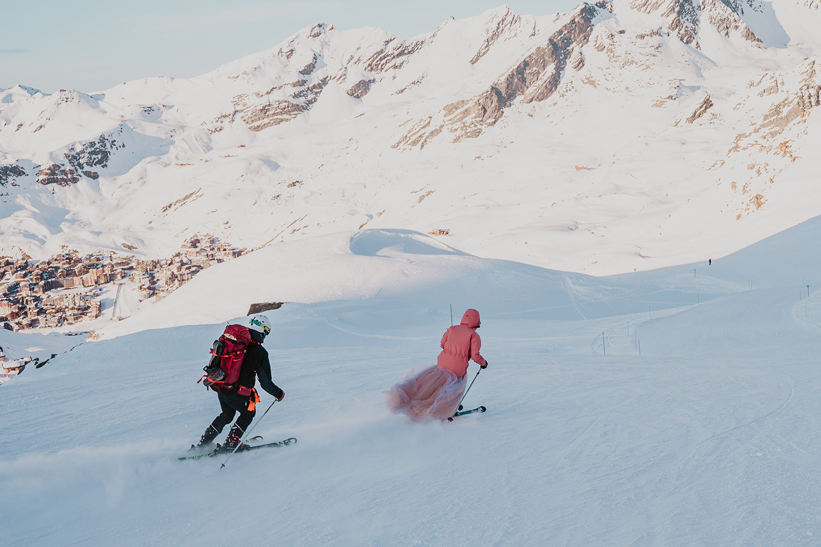 couple elopement in mountains French Alps Val Thorens Les Trois Vallees wedding skiing down weddingdress