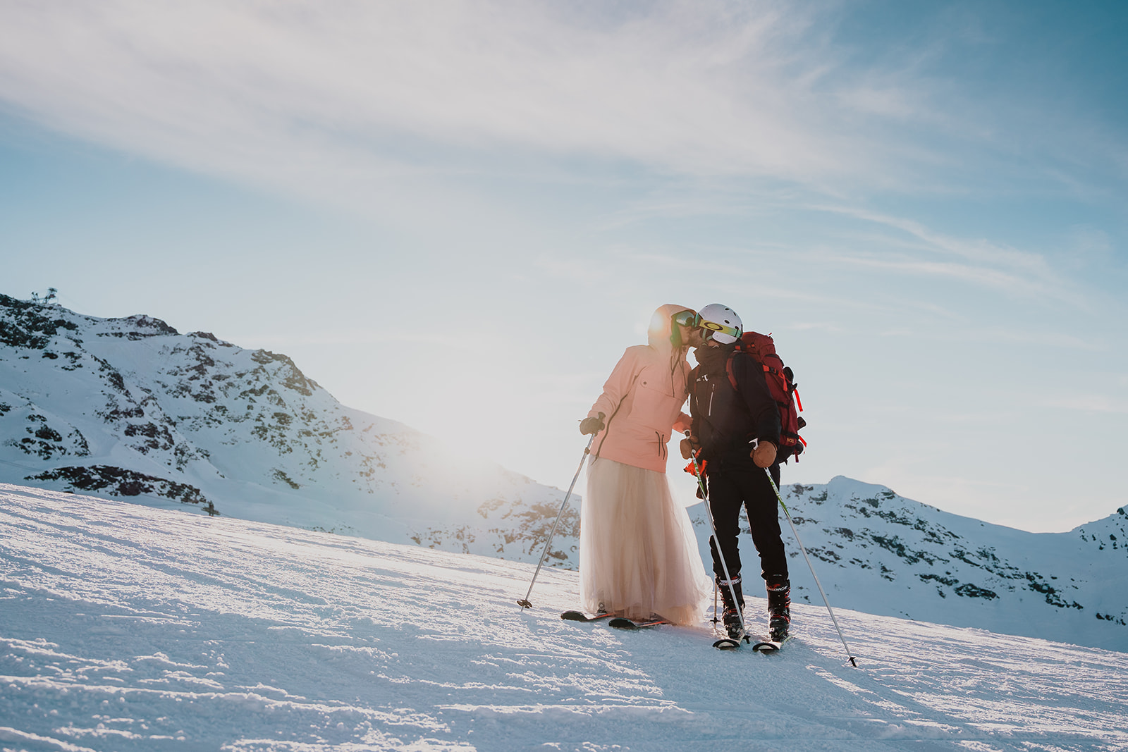 couple elopement in mountains French Alps Val Thorens Les Trois Vallees wedding skiing down weddingdress