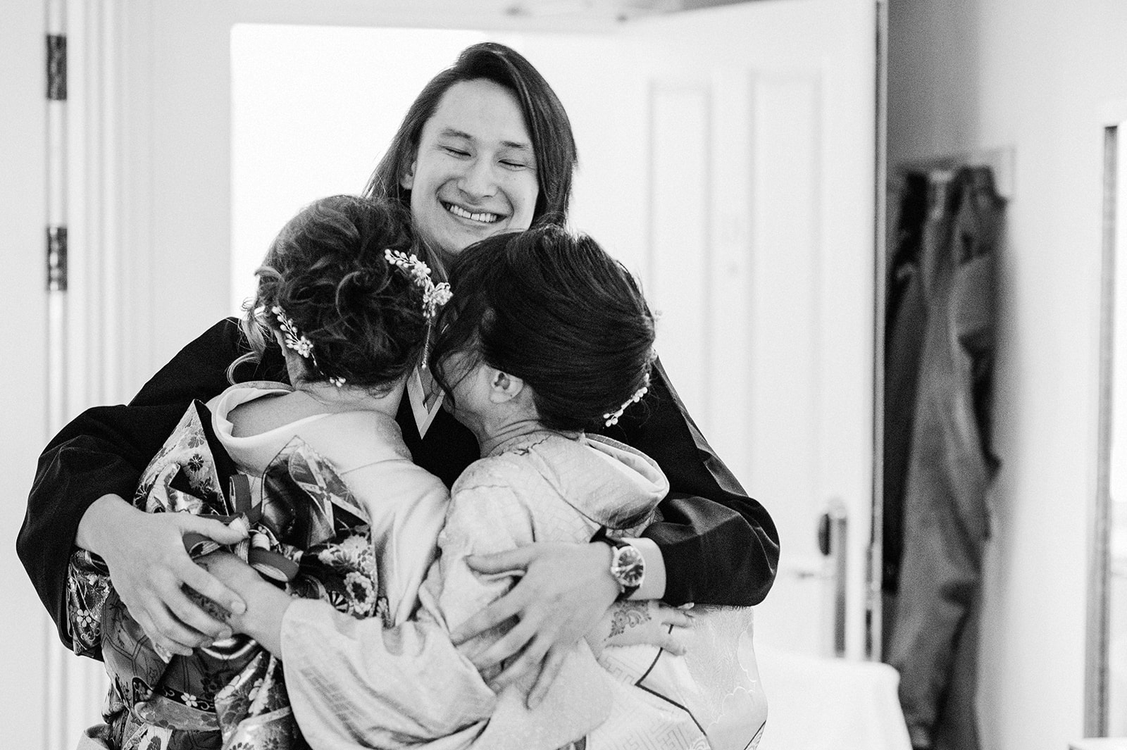 Groom hugs his mother and sister