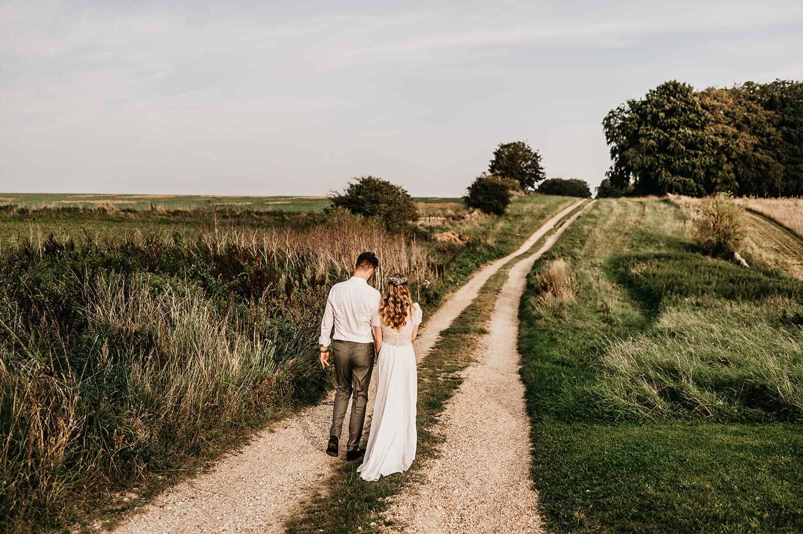 bride and groom take a golden hour walk 