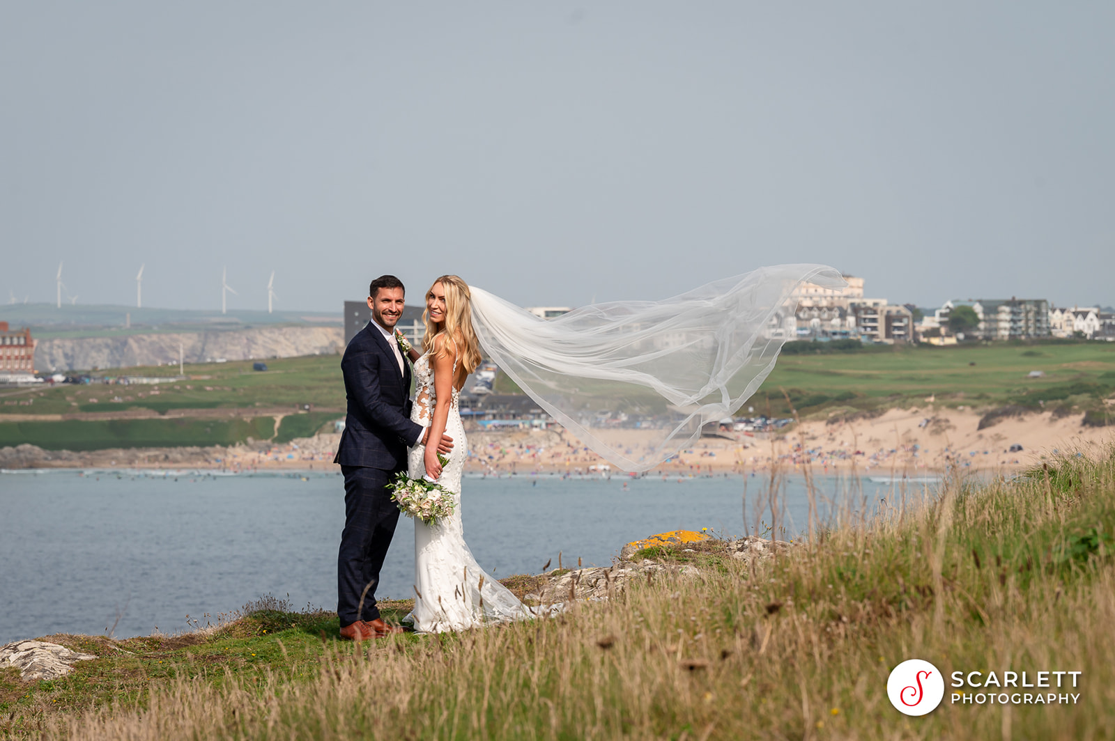 Wedding couple pose in front of the famous Fistral Beach in Newquay