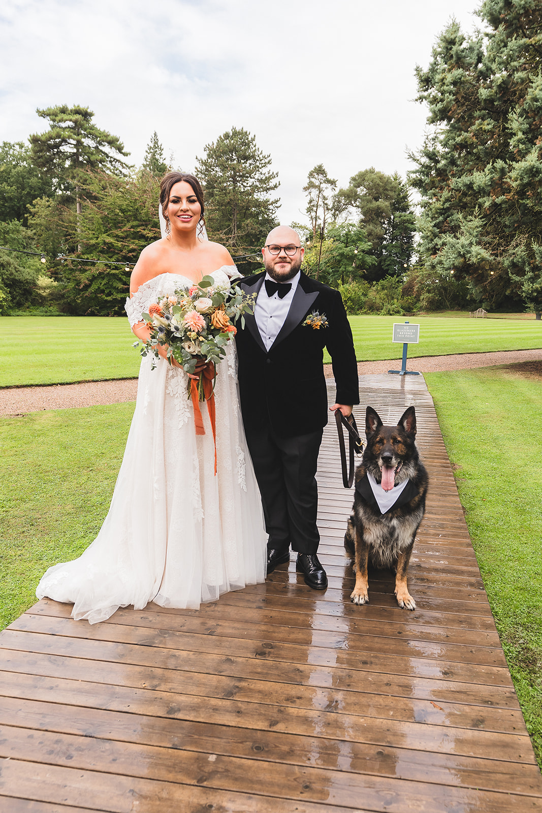 bride and groom with dog on wedding day
