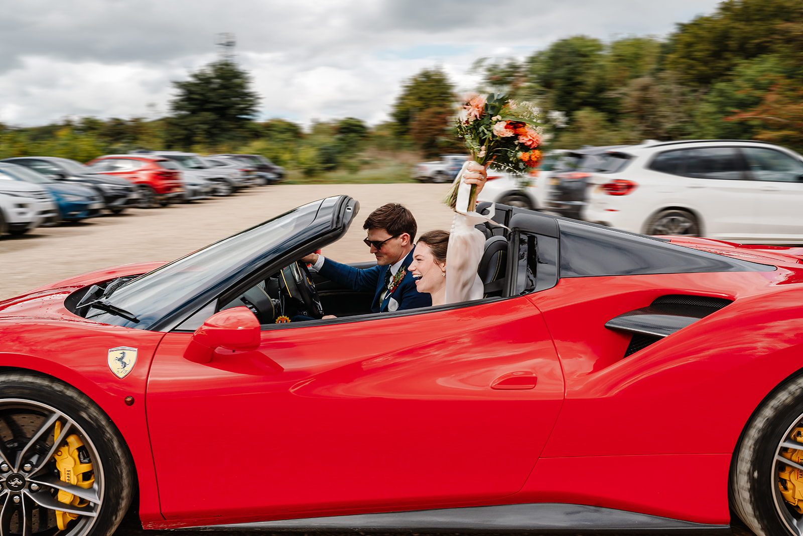couple in a Ferrari during wedding at Yard Space Old Gore wedding venue in the Cotswolds