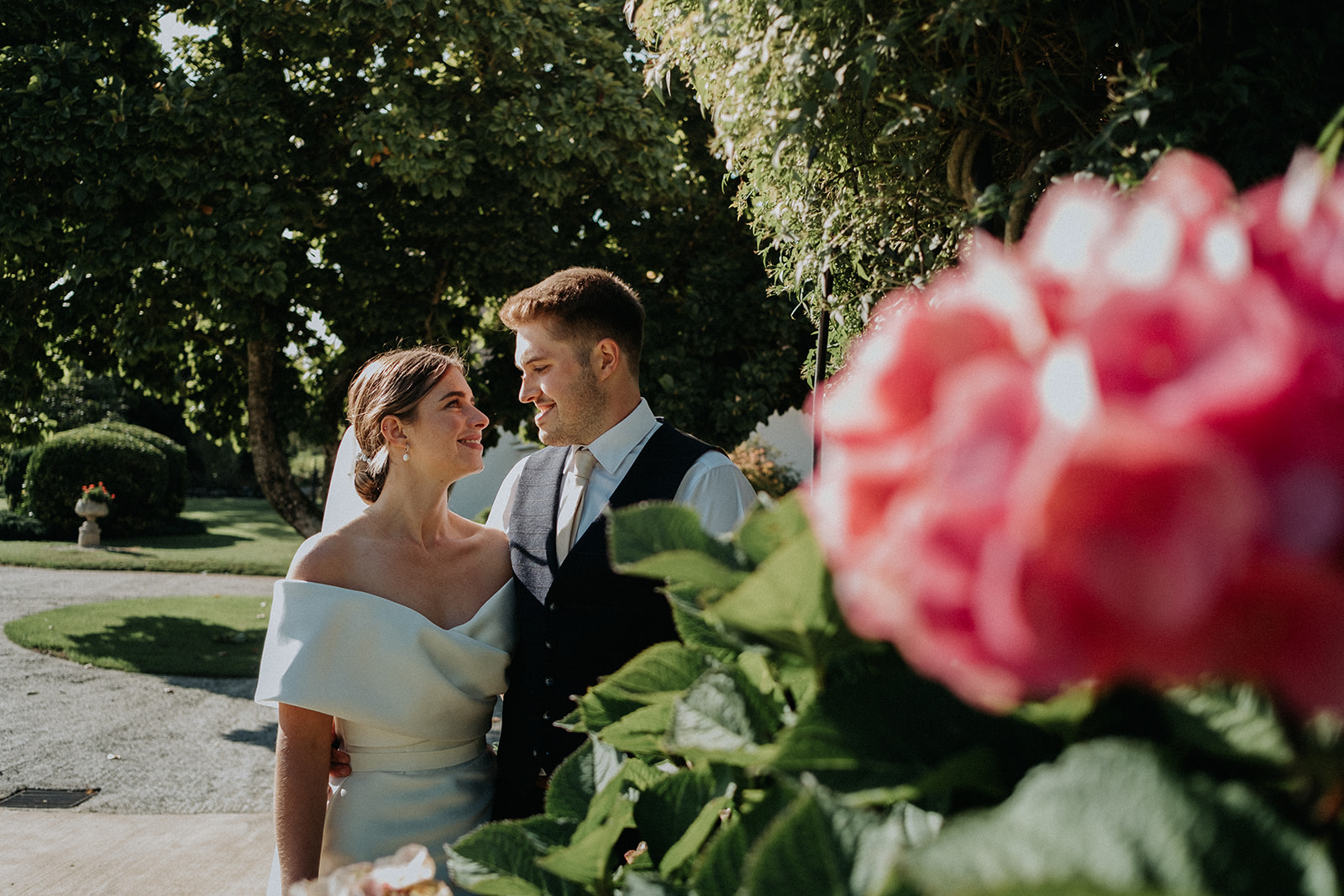 Love blossoming between Bride and Groom at Upton Barn walled garden image captured by Somerset Wedding Photographer