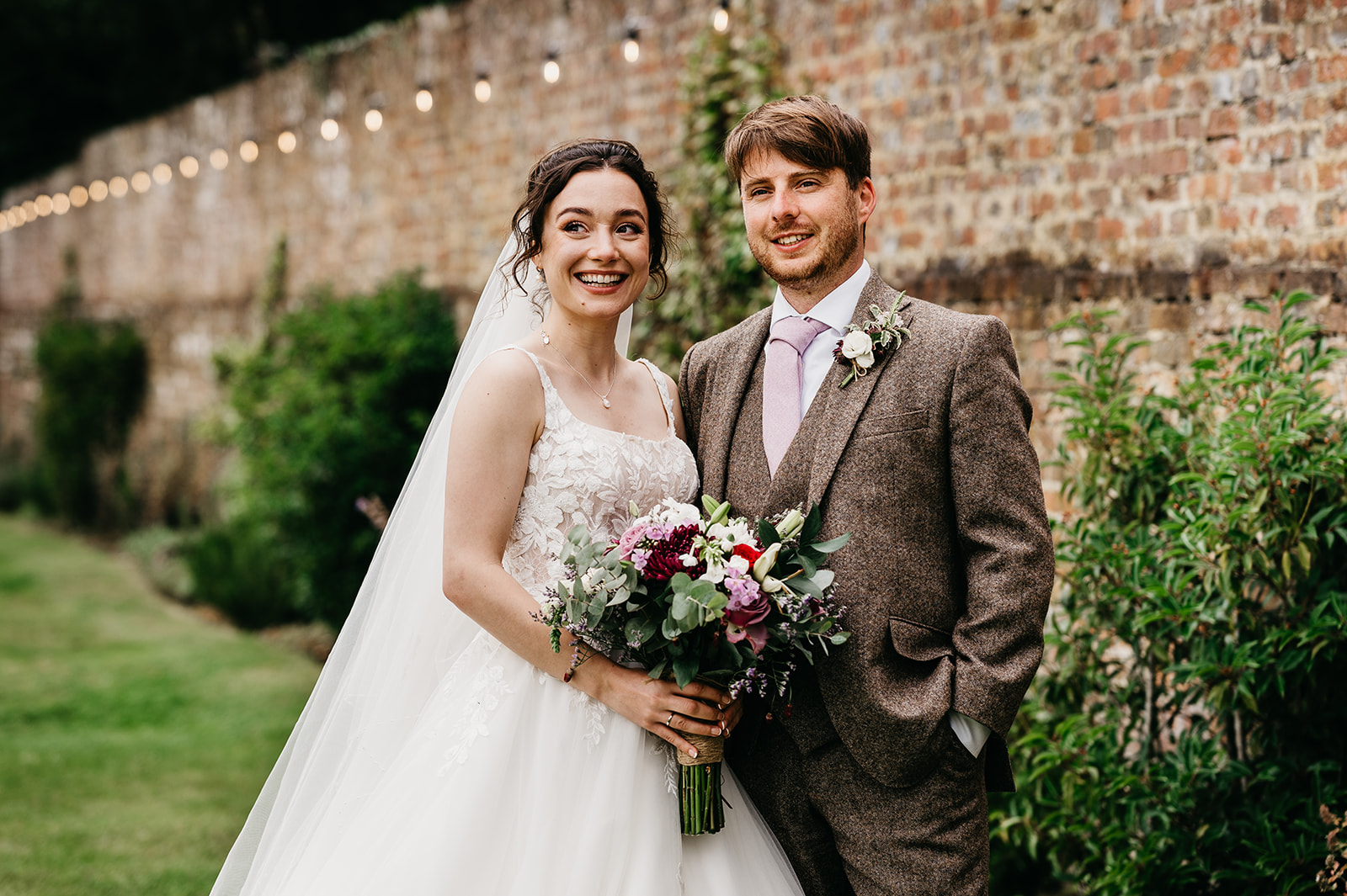 Bride and groom in Holywell estate walled garden 