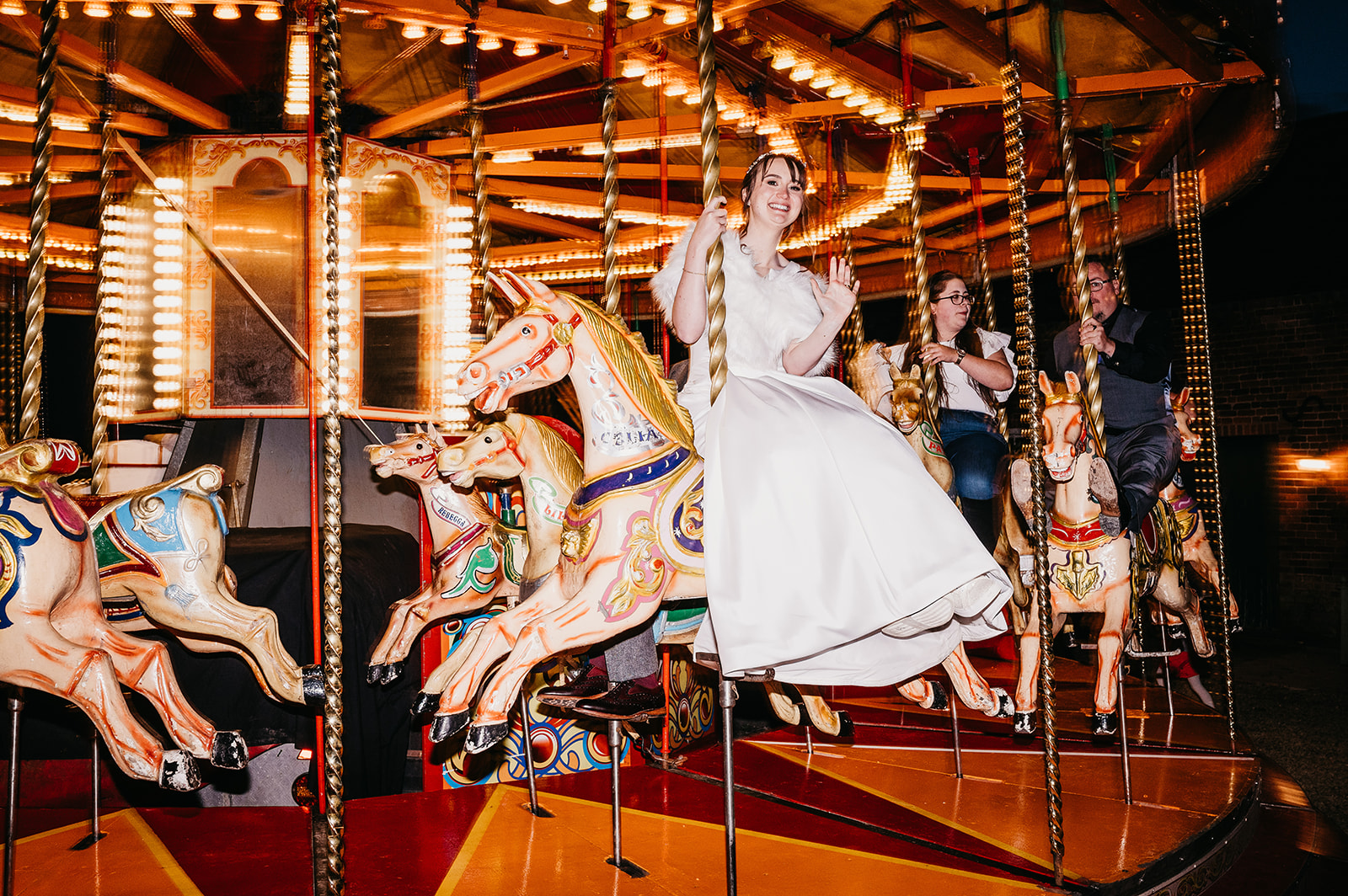 bride takes a ride on fairground carousel 