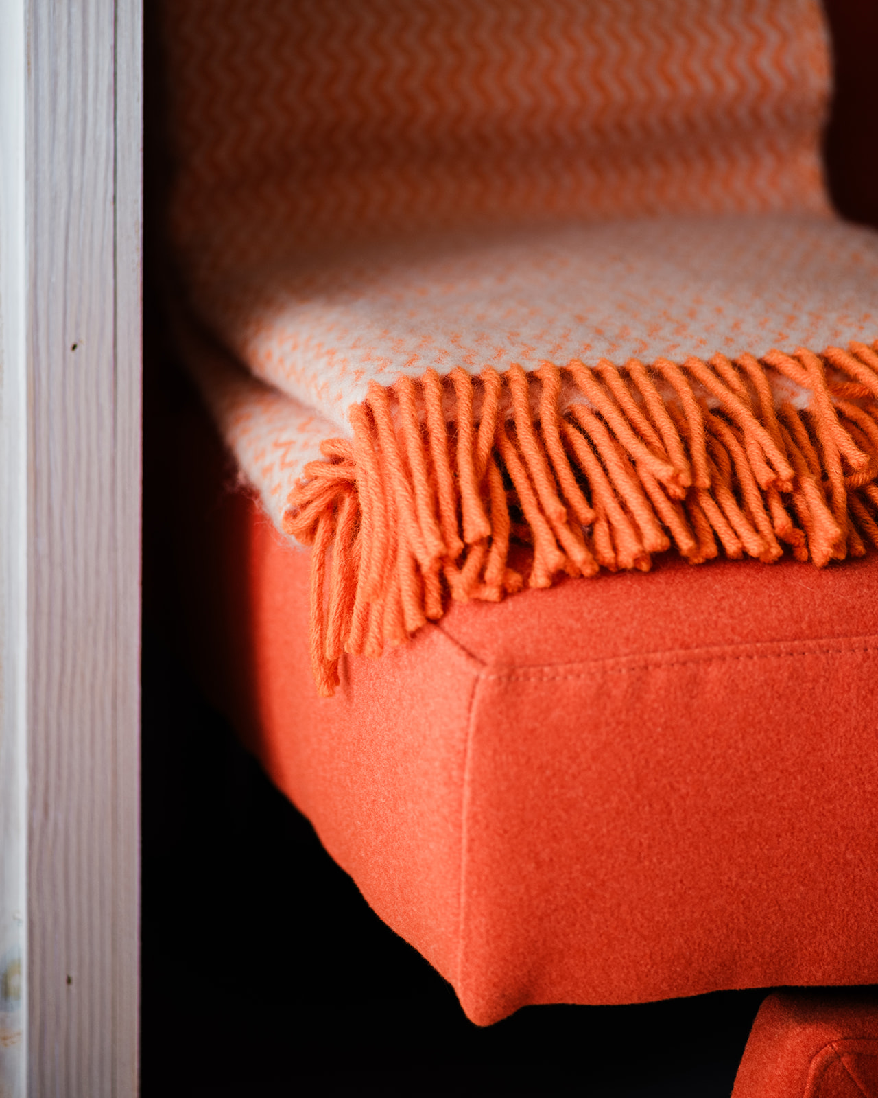 close of orange sofa and rug in interior design project in Essex