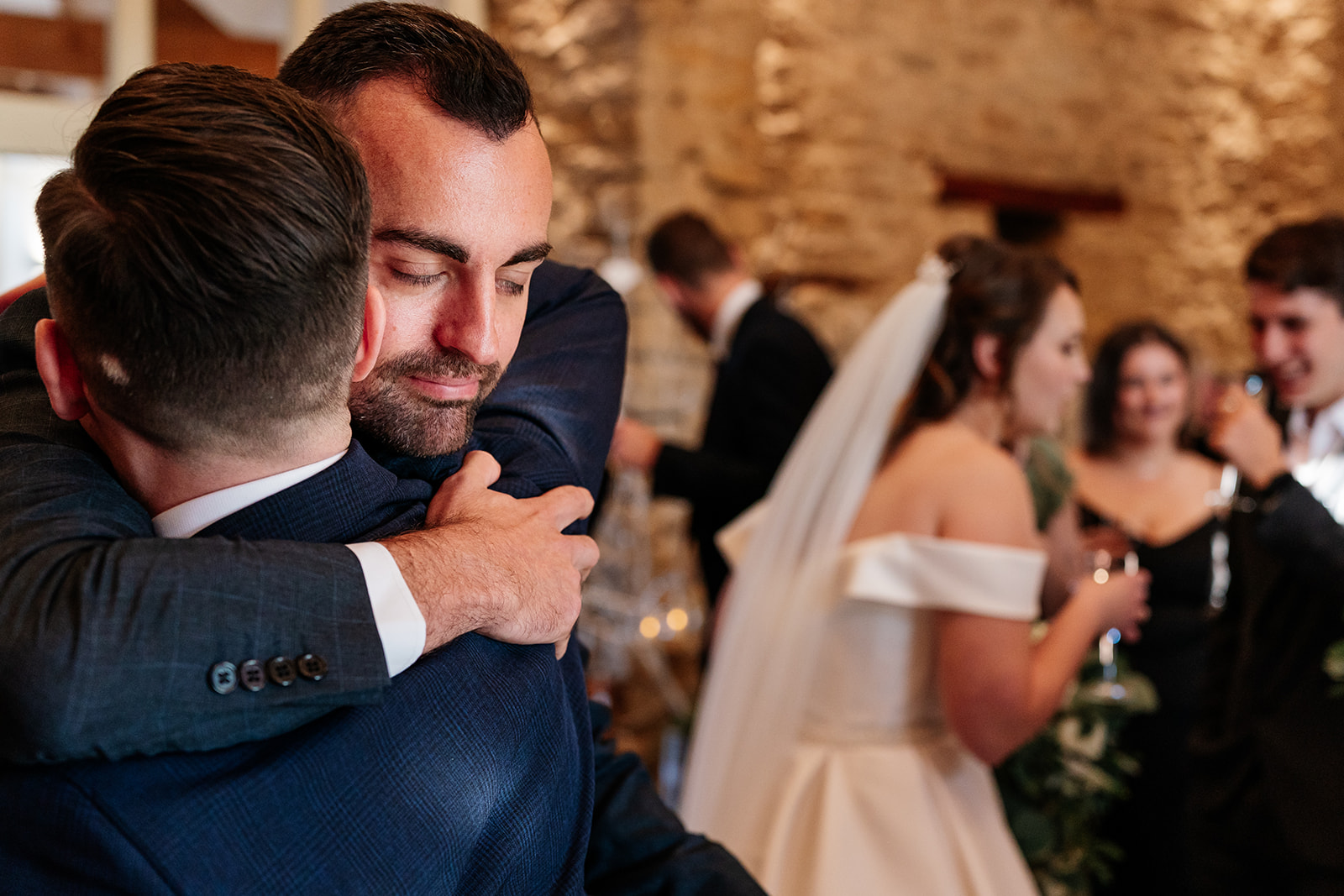 The groom receives a celebratory hug shortly after the ceremony 