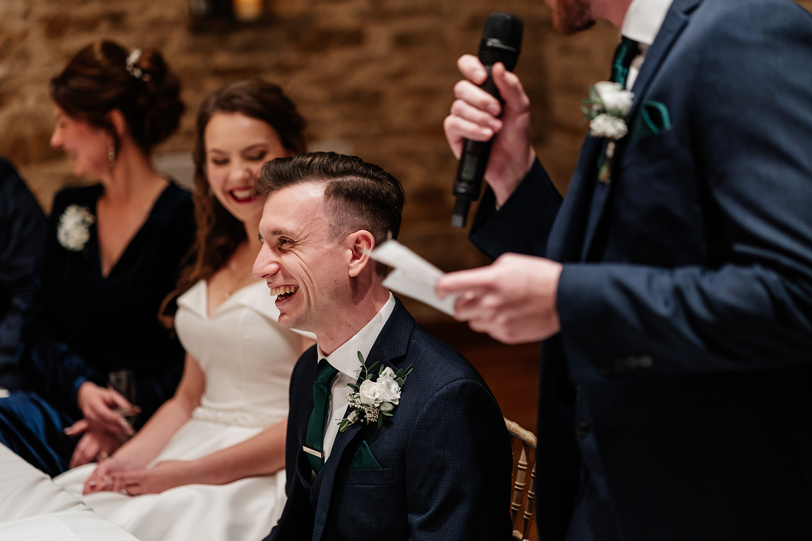 Best men giving a speech and groom laughing 