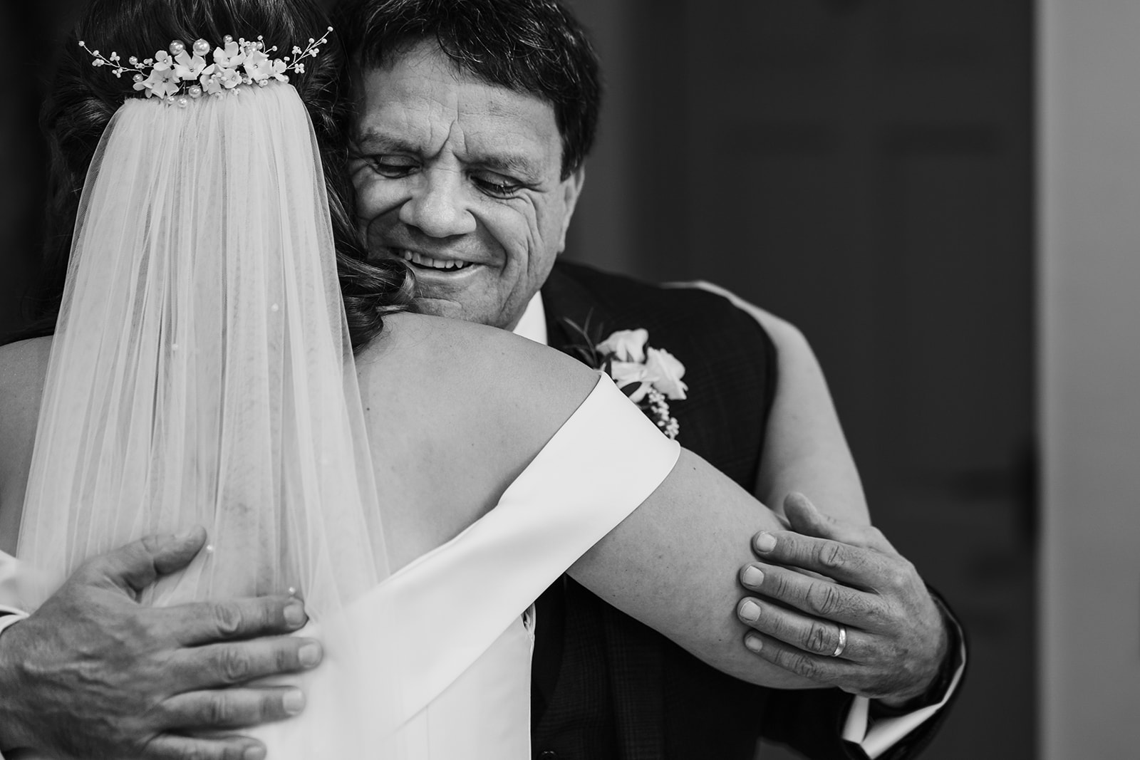 Father of the bride hugging his daughter before the wedding ceremony 