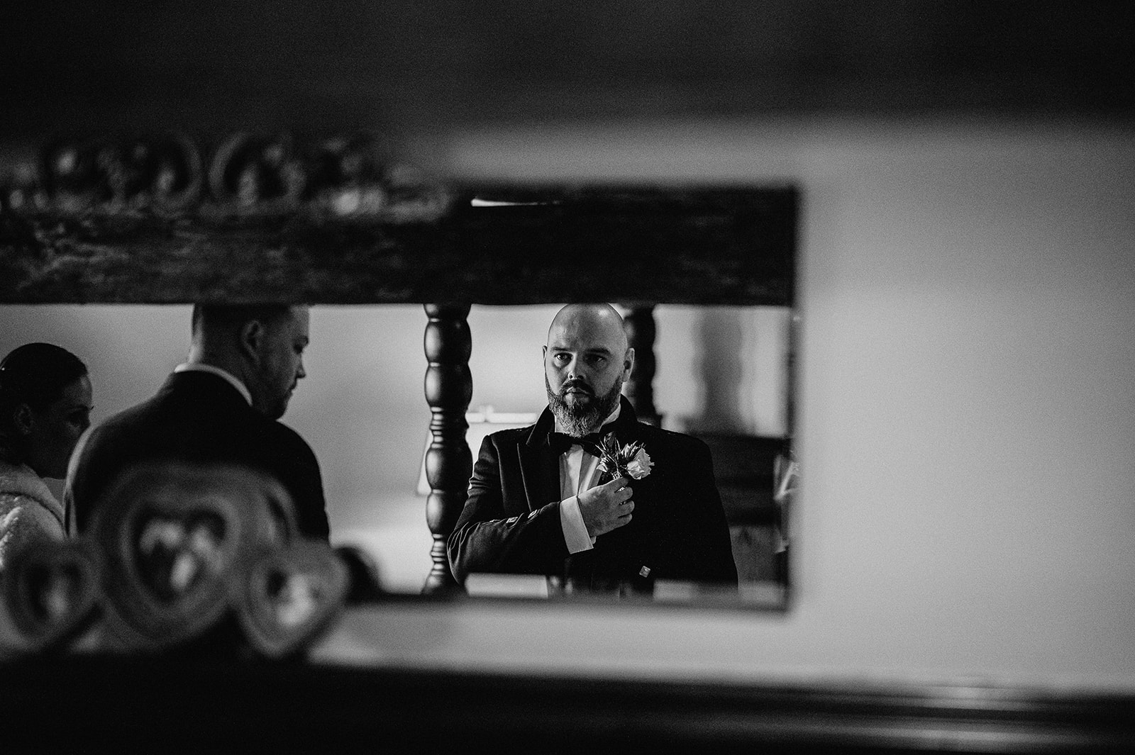 groom looking through mirror