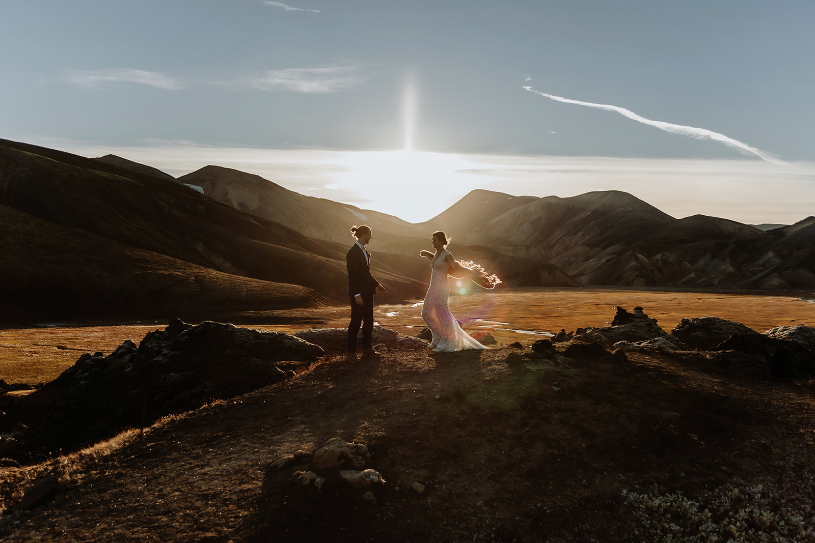 Bride and Groom embracing the weather during sunset on the highlands in Iceland
