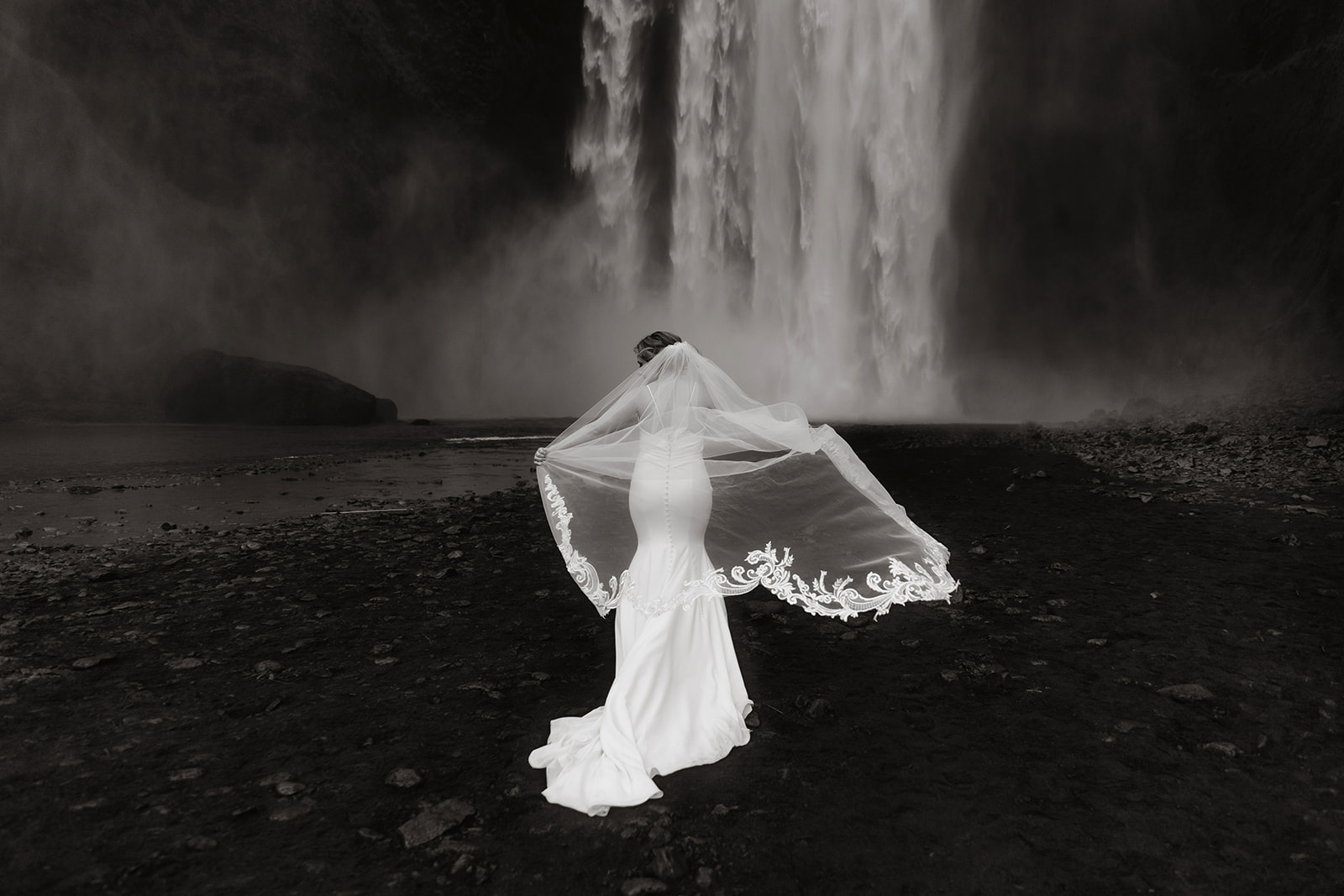 Bride is in front of the Skogafoss waterfall