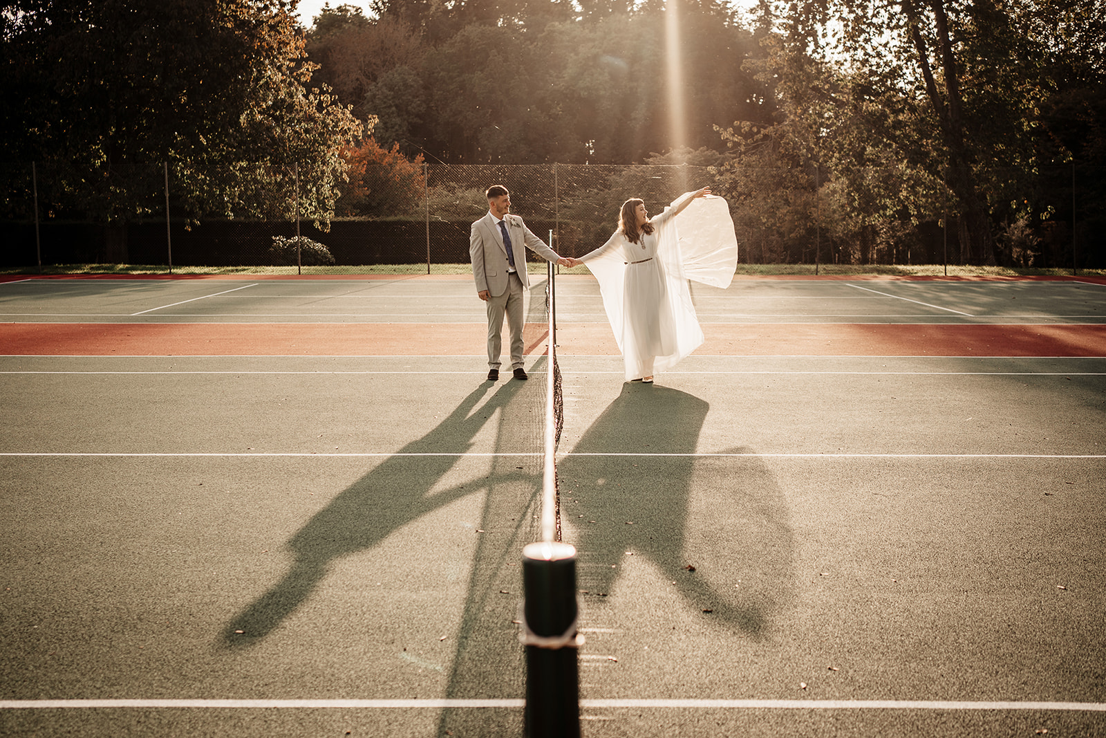 bride and groom on tennis court