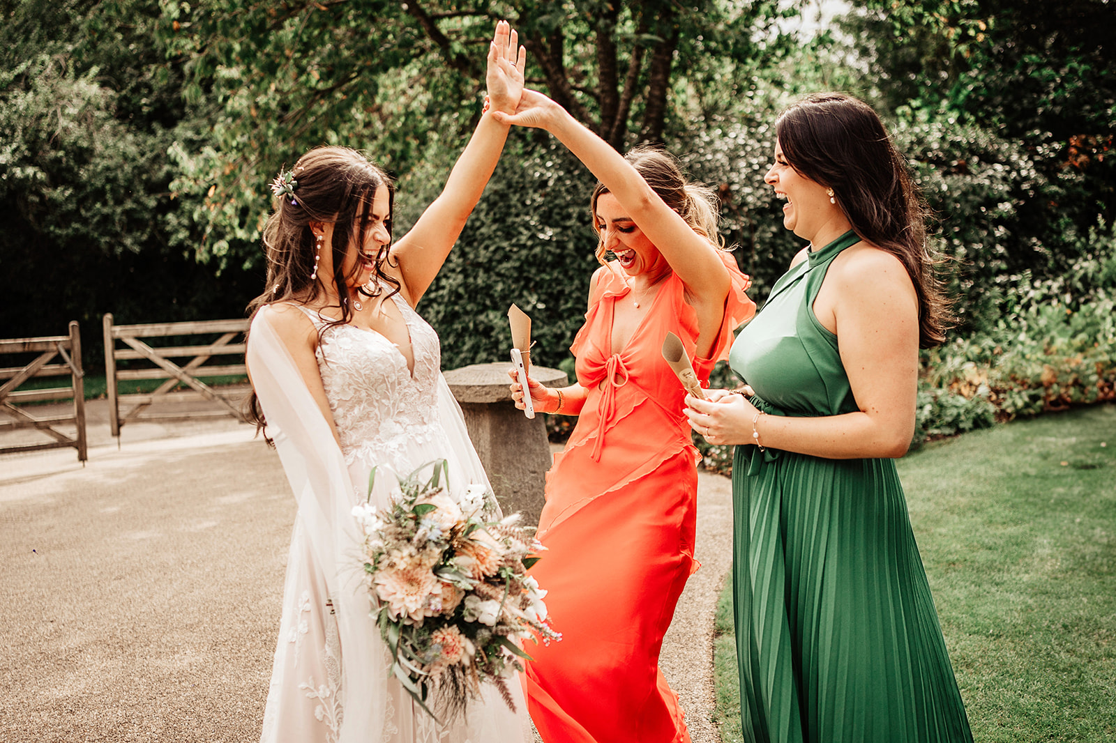 bride showing her wedding ring off to friends 