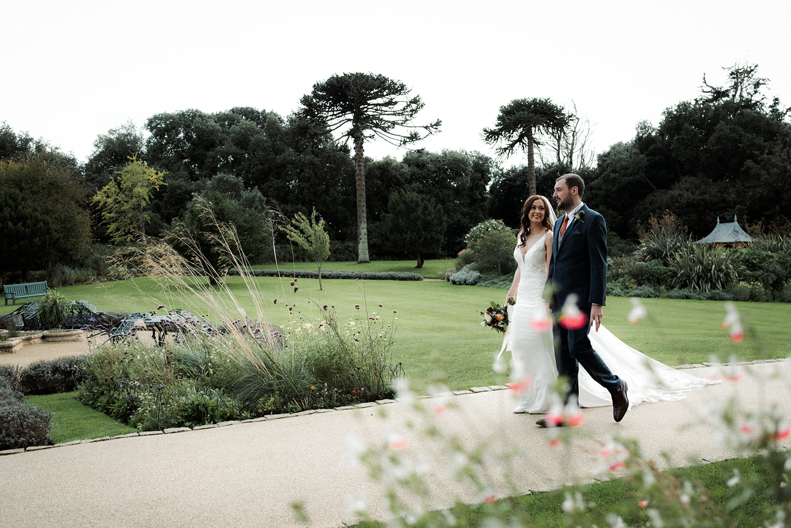 A couple take a stroll hand in hand in the grounds of Clevedon Hall Somerset