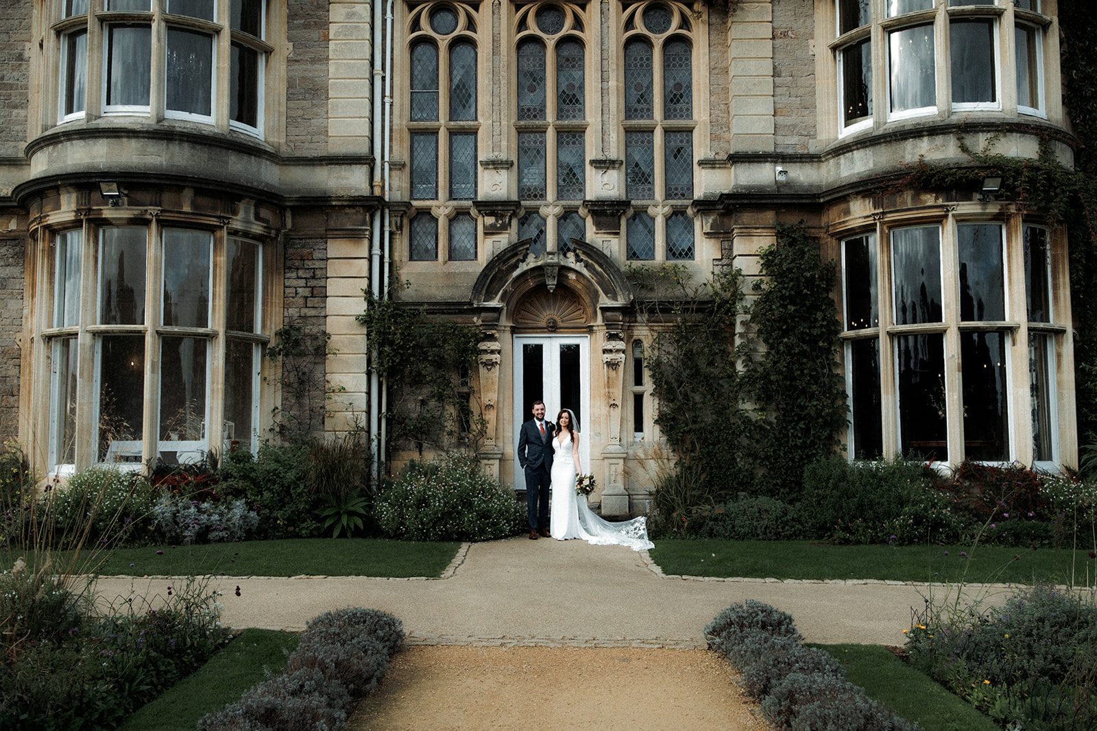 Romantic image of couple in front of Clevedon hall entrance
