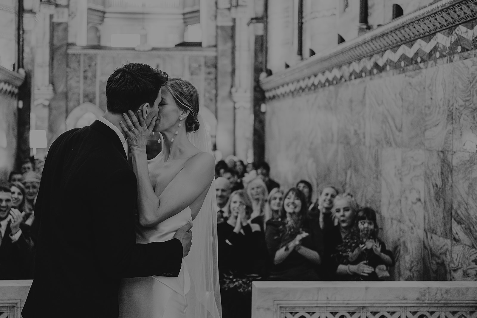 First kiss at wedding ceremony in Fitzrovia Chapel