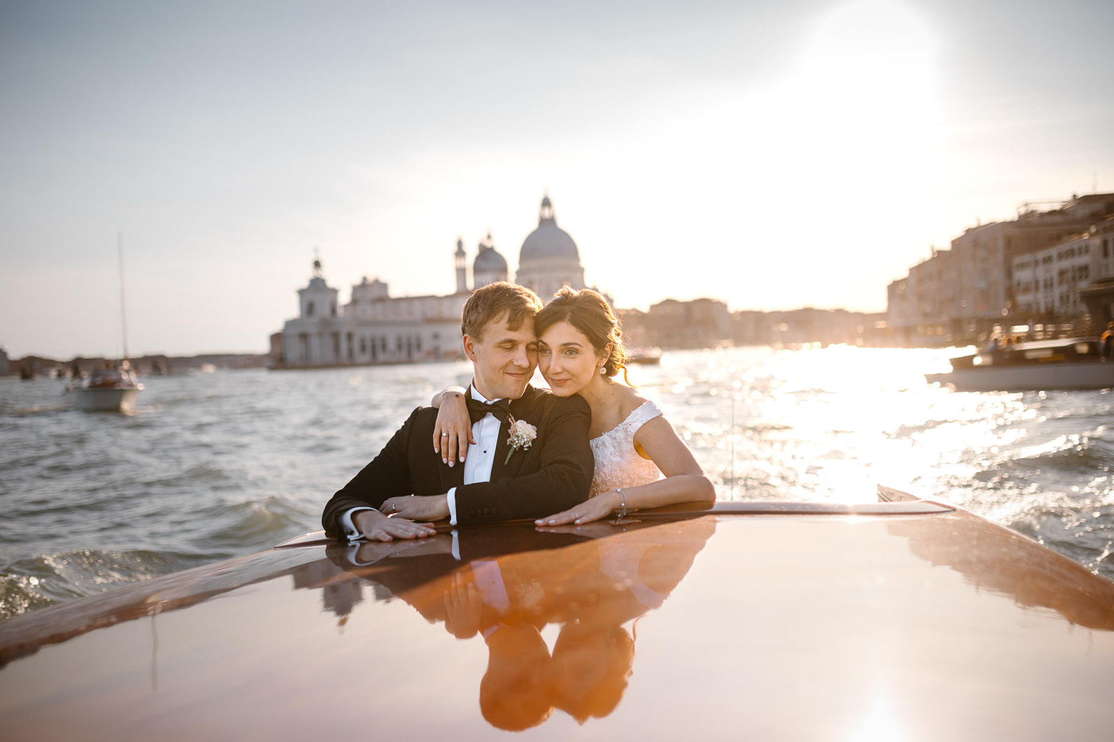 Bride and groom on a boat in front of Piazza San Marco in Venice