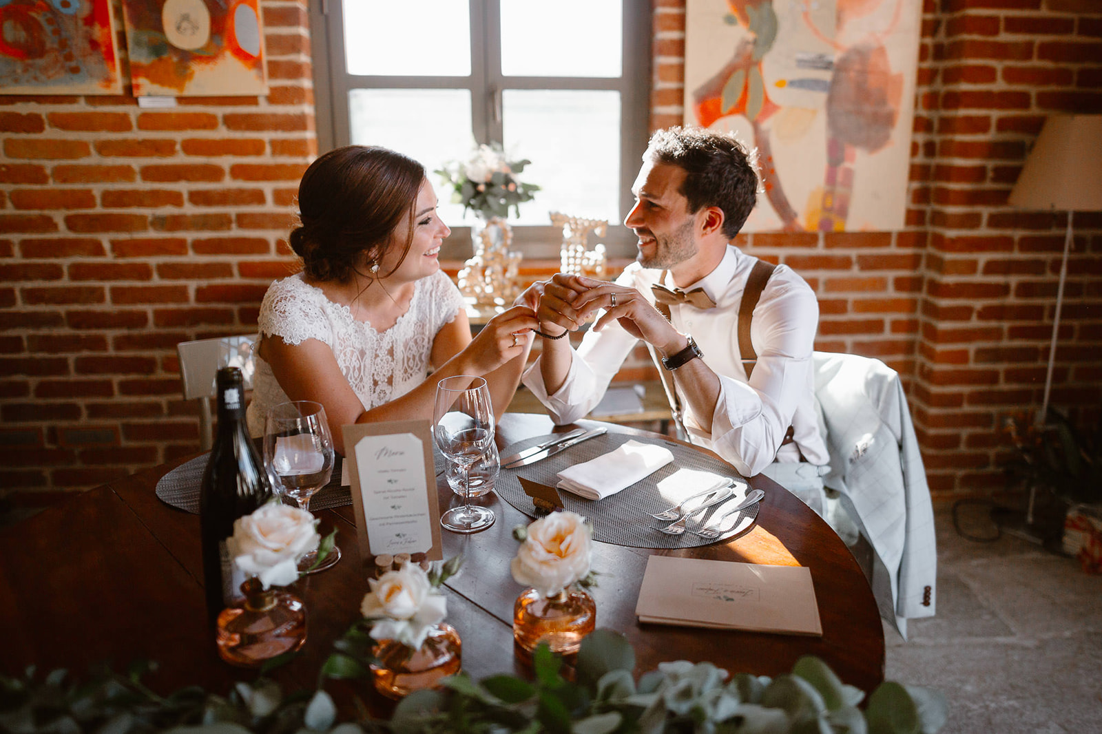 newlyweds sitting at their wedding dinner table on their Italian wedding in Piedmont