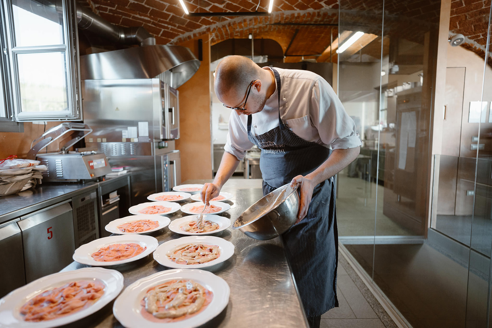 Italian chef at work during a wedding in Cascina Faletta, Italy